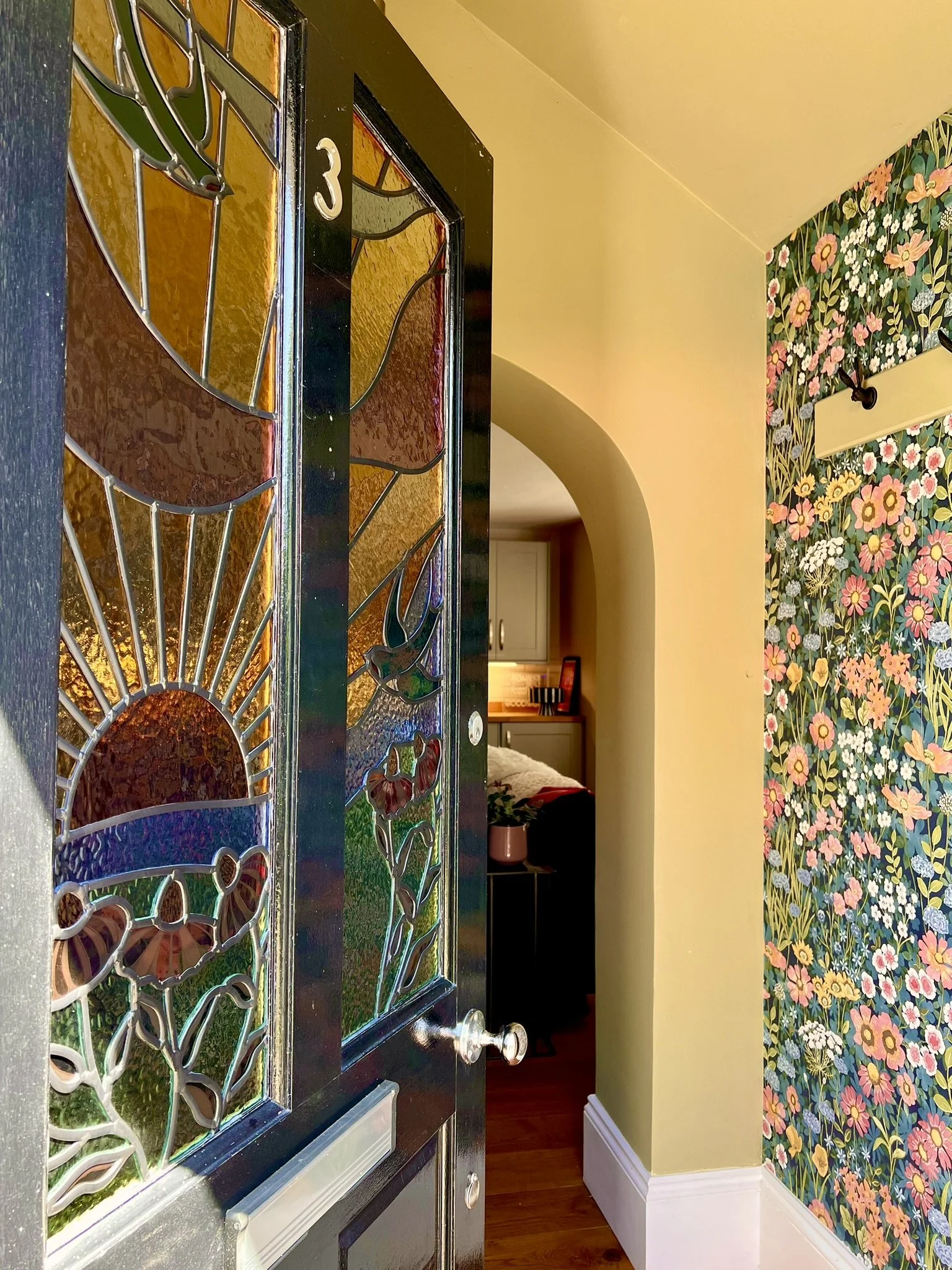 maximalist stained glass front door set featuring swallows, a sunset and fuchsia pink cone flowers