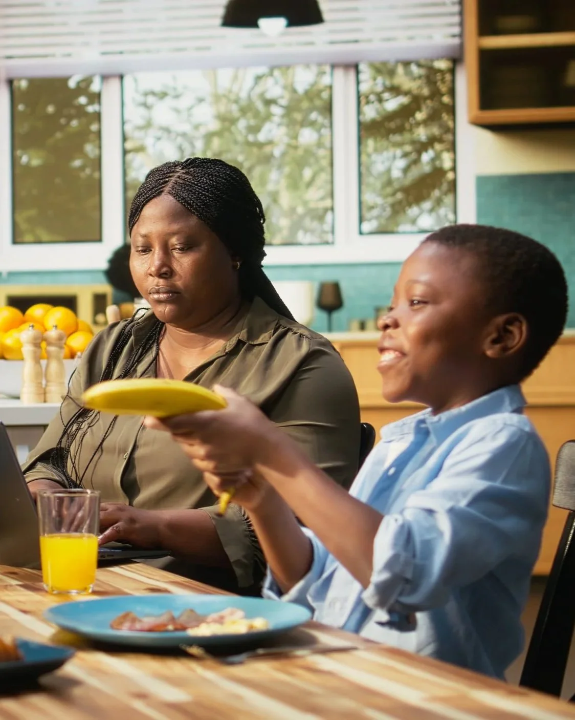 boy eating breakfast with family