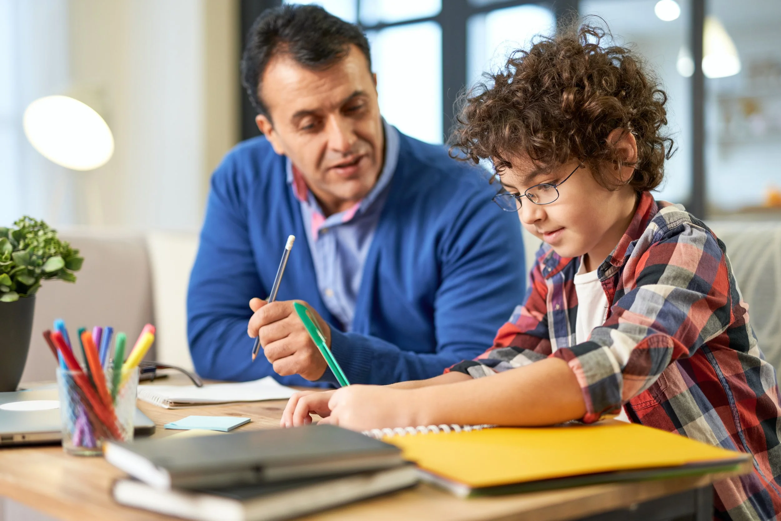 father helping son with homework