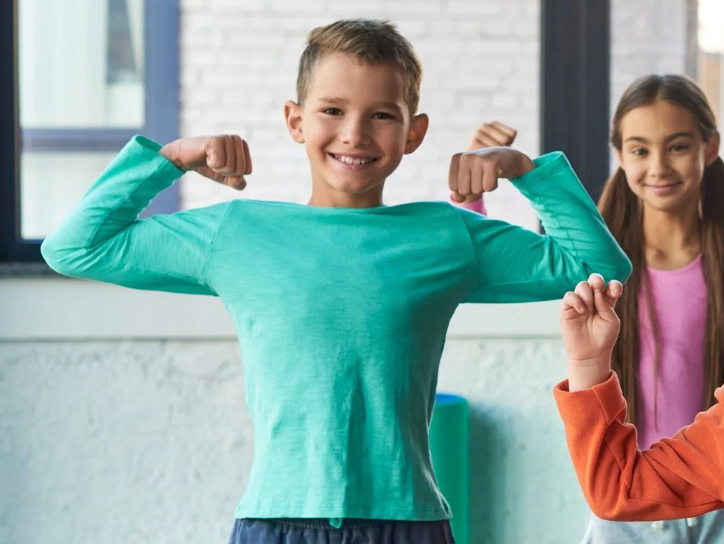 child flexing confidently