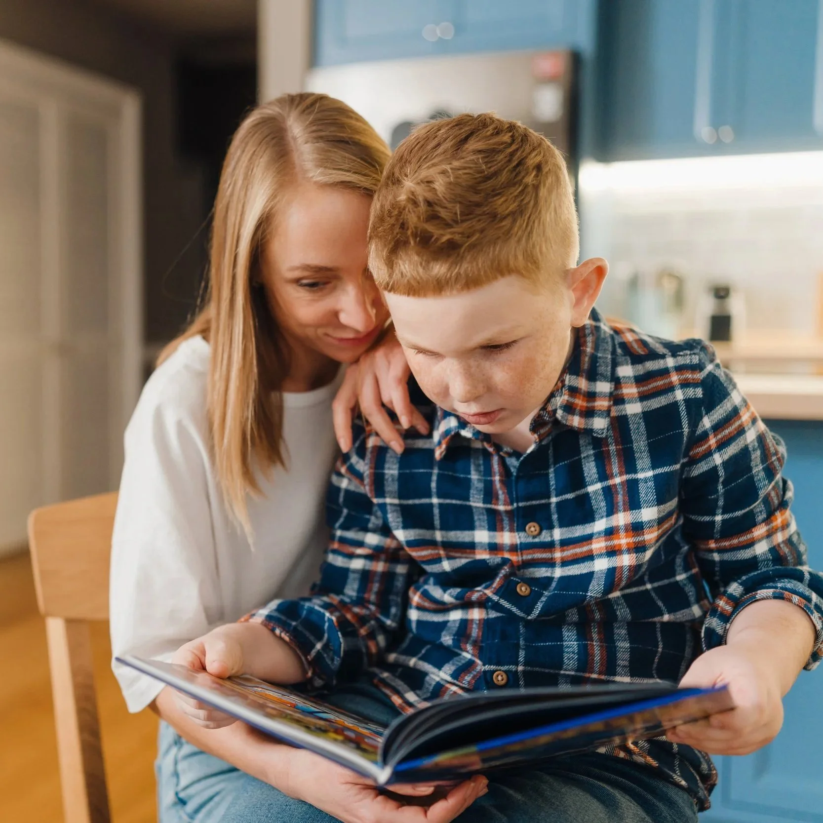 boy reading on mothers lap