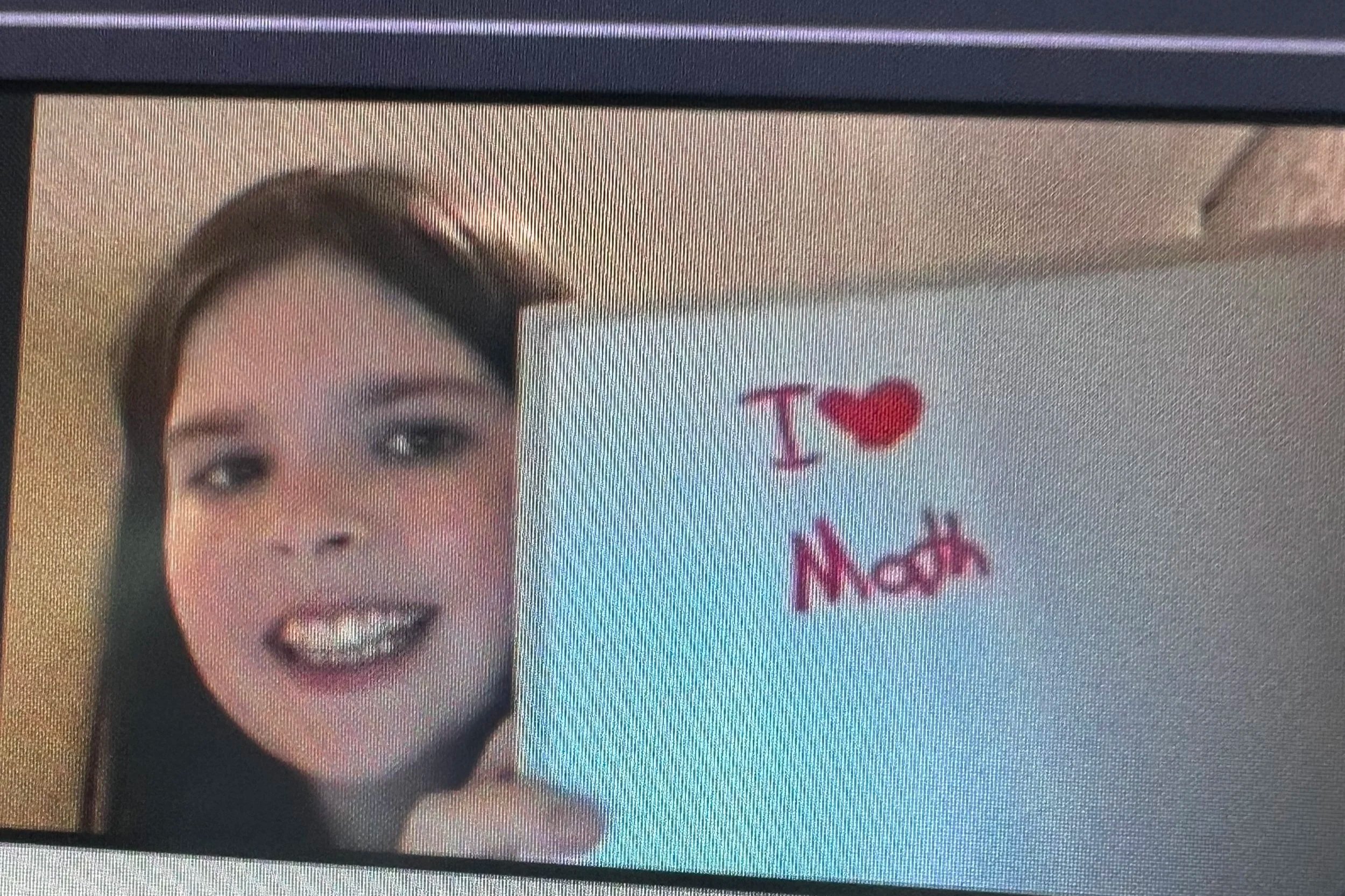 girl holding a sign that says "I heart math"