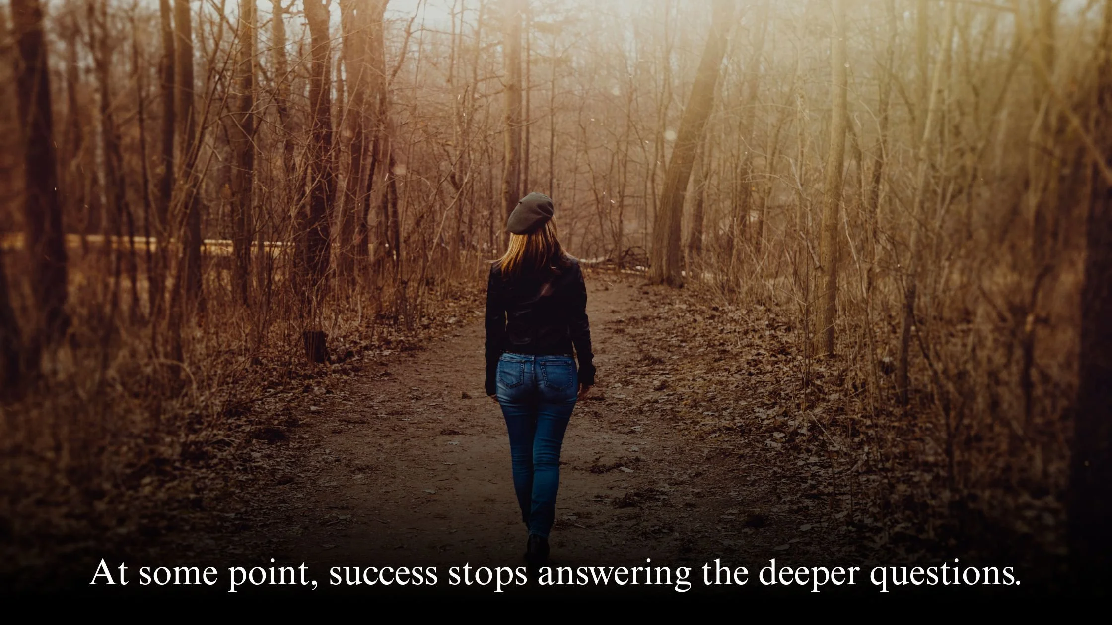 Woman walking alone on a coastal path symbolising career transition and redefining success in midlife