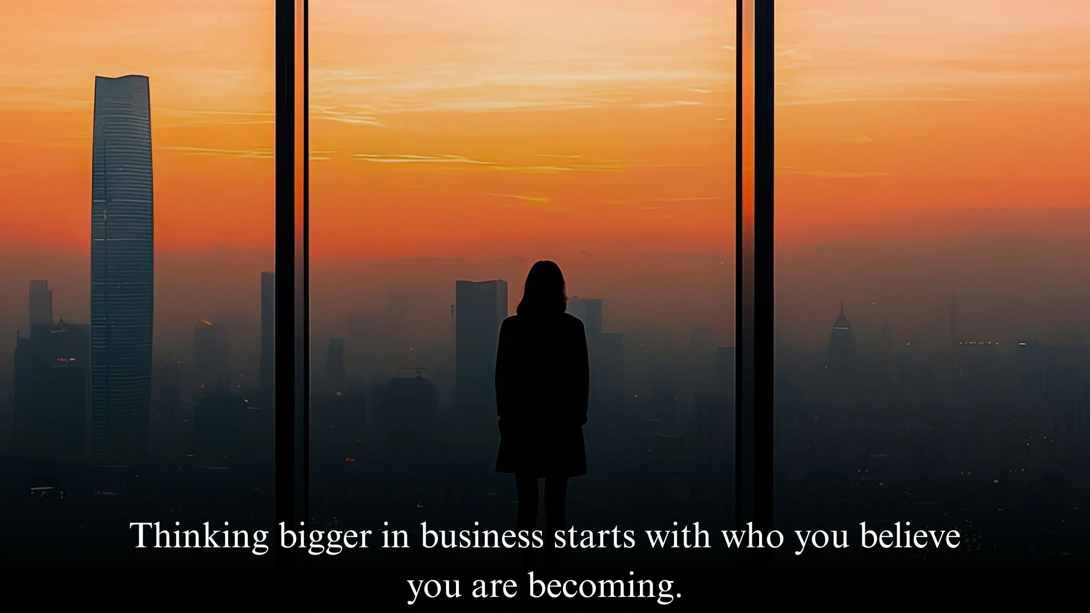 Midlife female entrepreneur looking over city skyline at sunrise representing business growth mindset