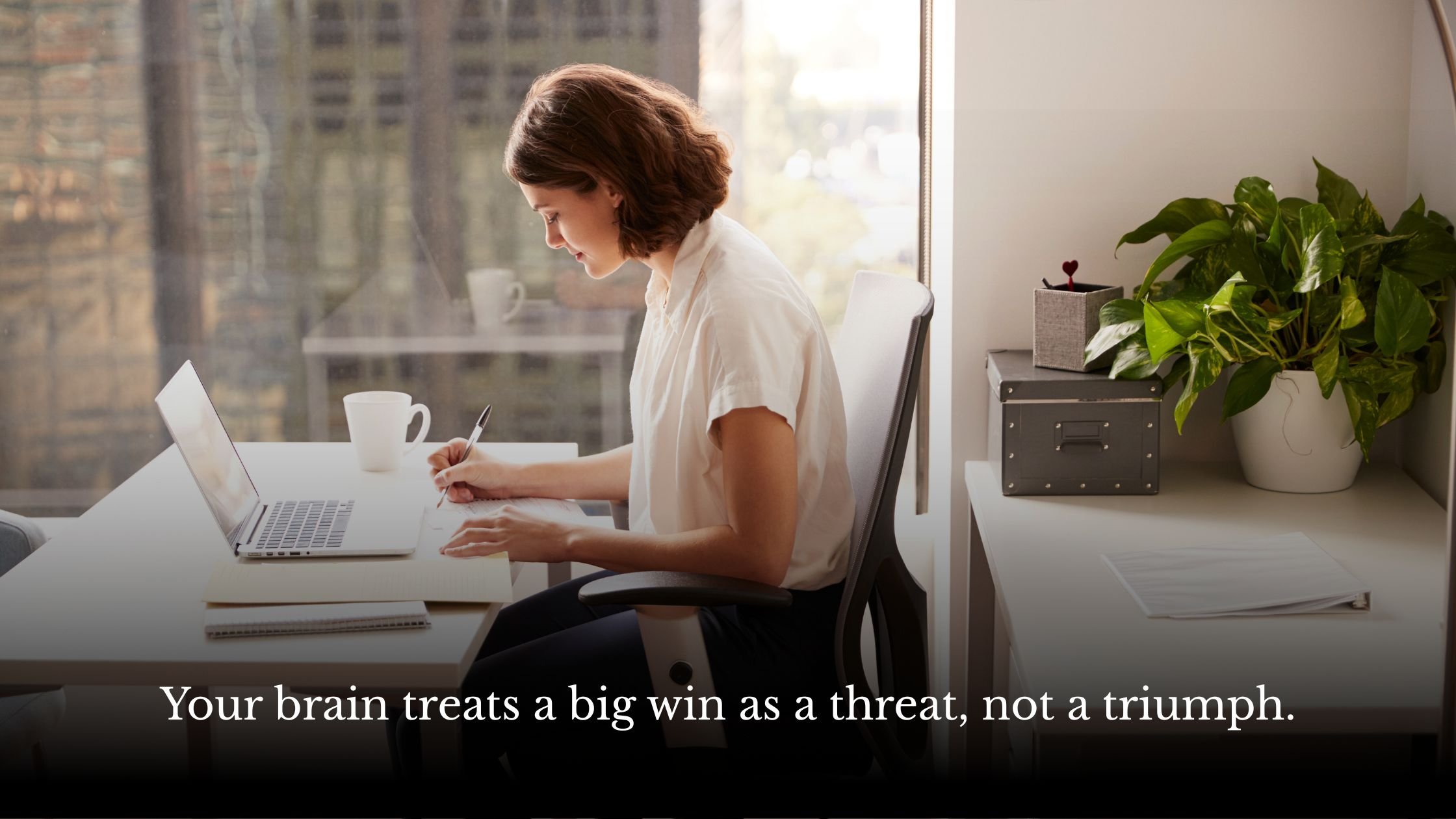 Woman pausing with her hand over a laptop keyboard, symbolising procrastination and the primitive brain, Jo Renshaw Life Coach Brighton blog