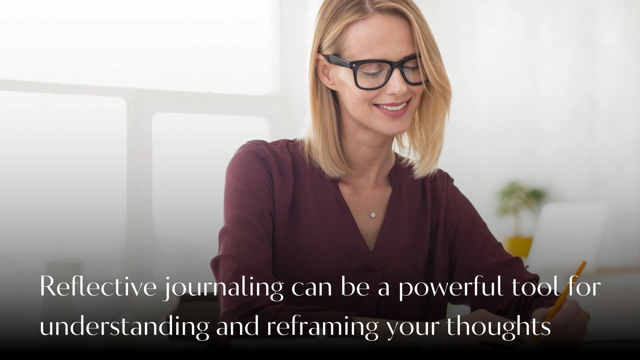 Confident woman journaling at a desk, reflecting on self-acceptance and growth.