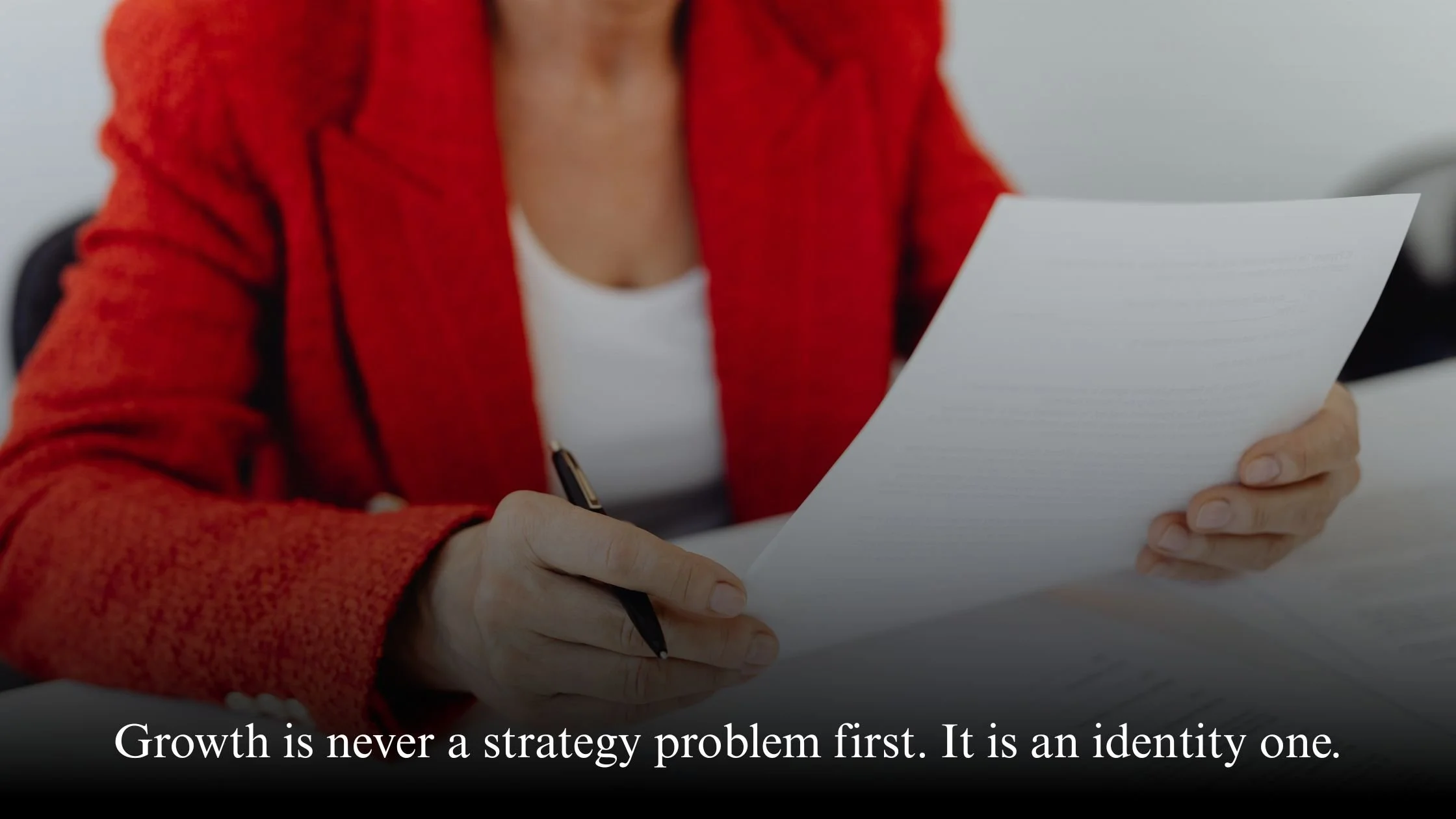 Confident female CEO reviewing business plans representing identity-based leadership