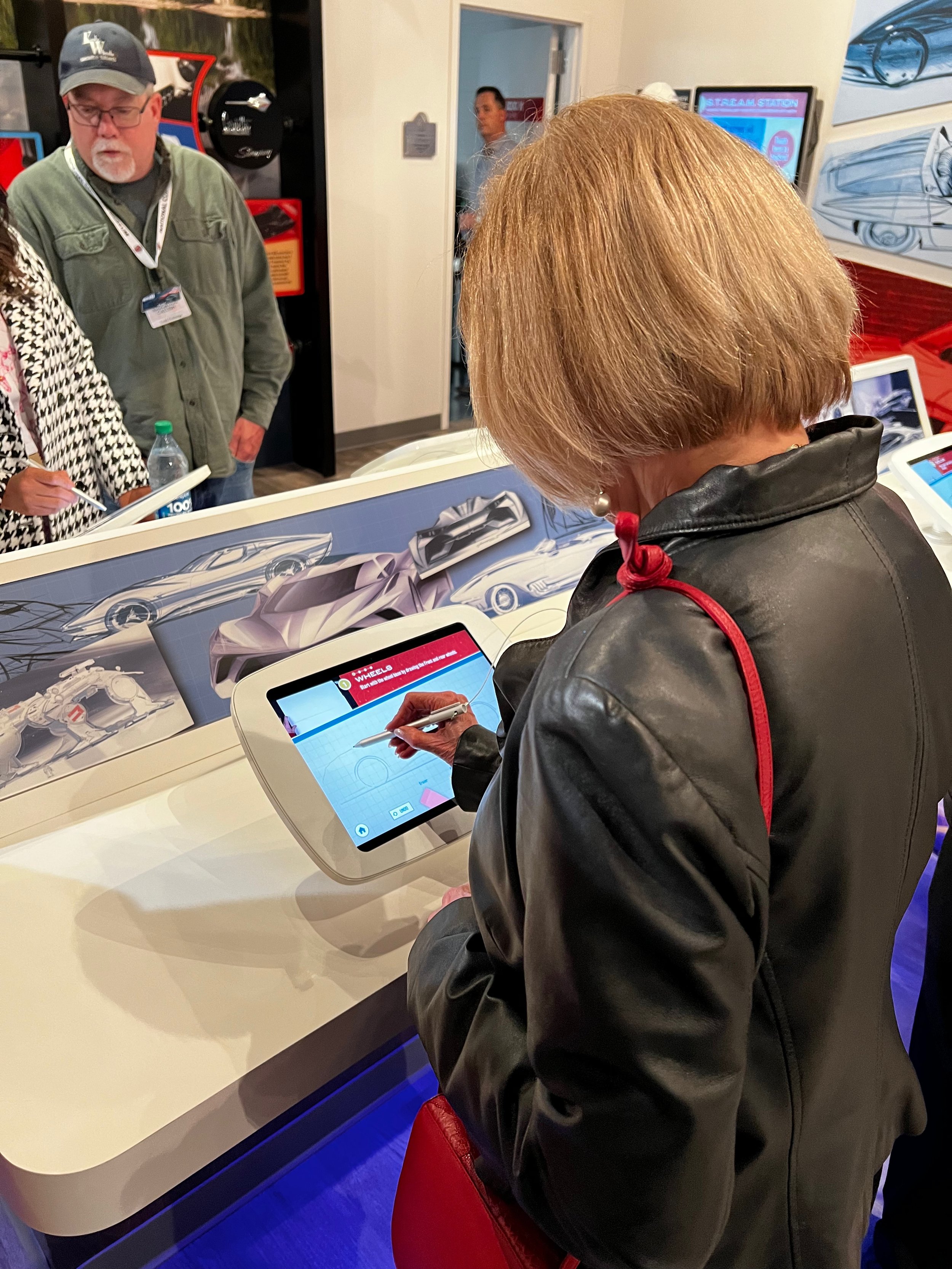 Bonnie Taylor trying out the "Draw Your Own Corvette" tablet