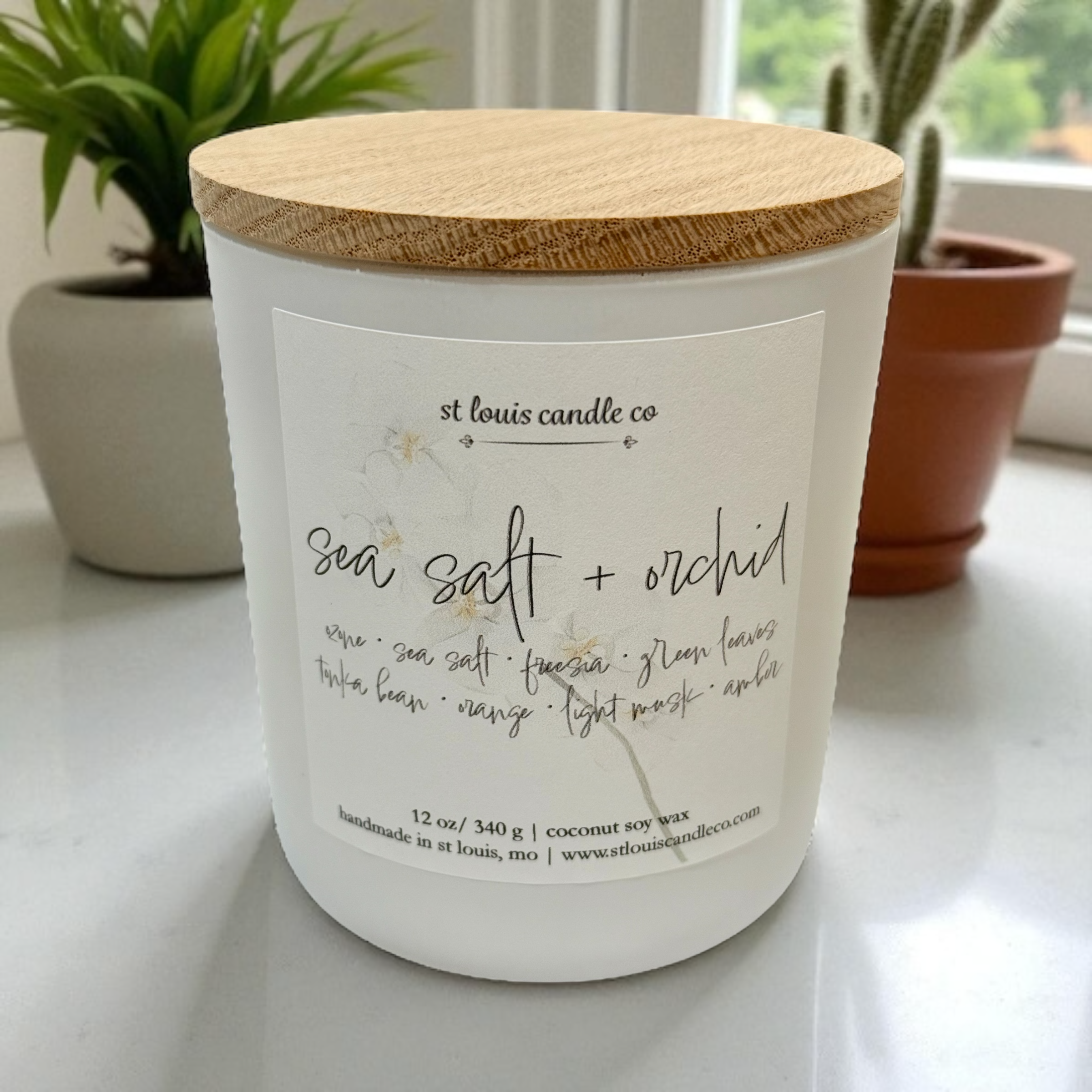 candle with wood lid in kitchen window