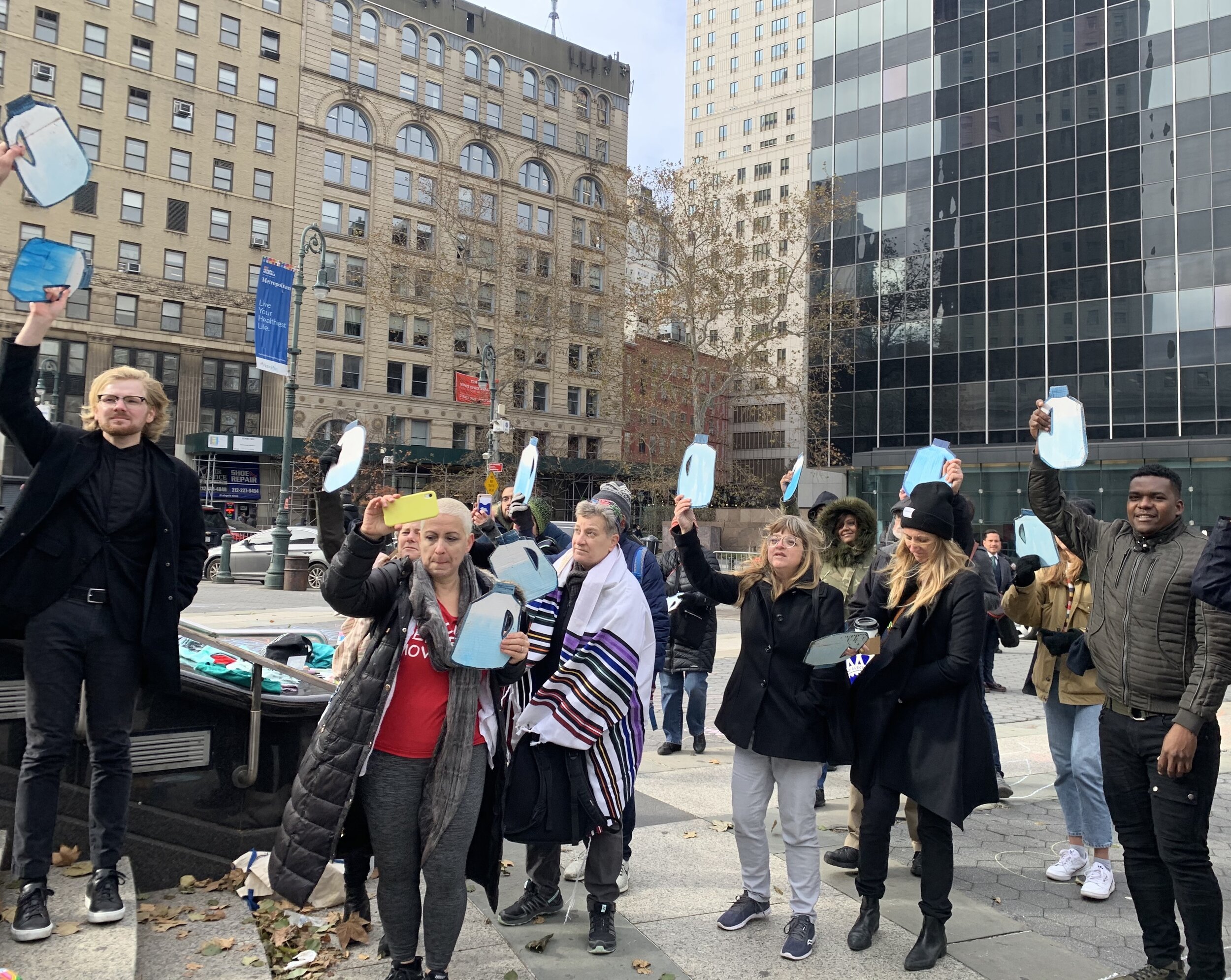  Scott Warren supporters rally in Manhattan with cardboard water jugs on Nov. 20, 2019. Pablo Suazo is seen on the far right.  Photo Credit: Jude Joffe-Block 