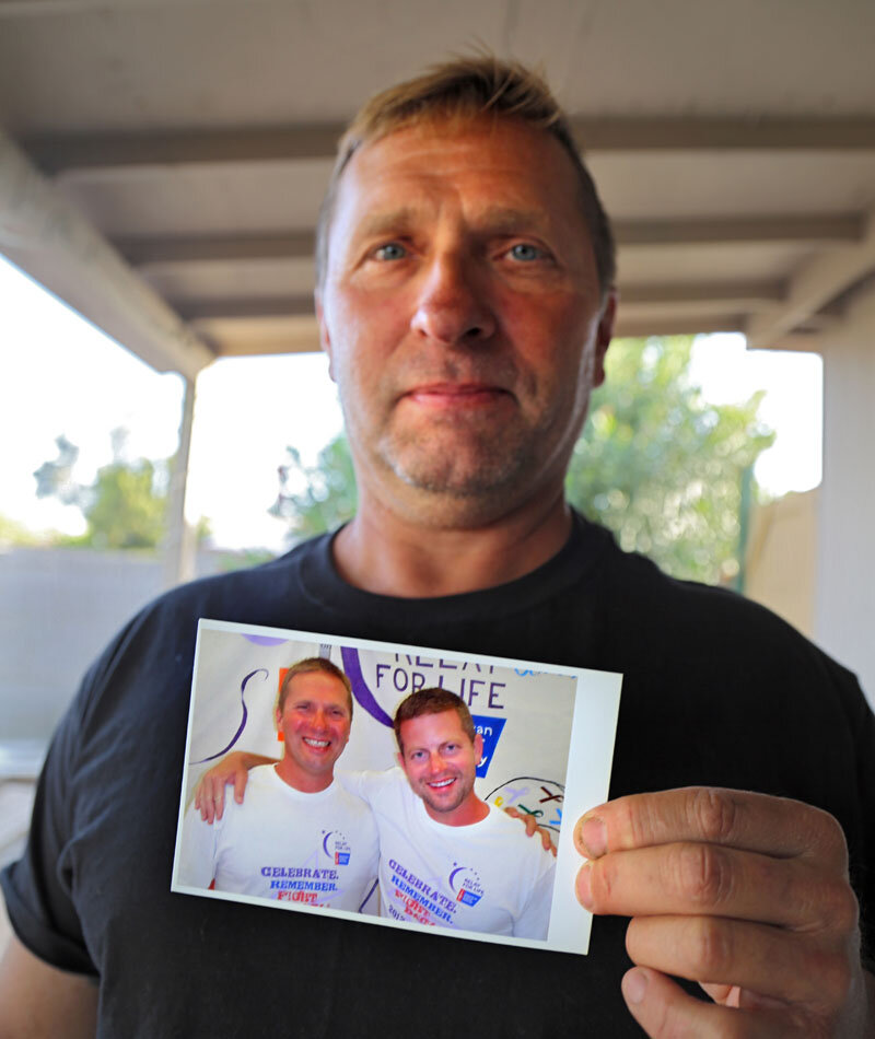 Troy Froehlich holds a photo of he and Gary Shepherd, taken while they were both still in prison.  Photo Credit: Mark Betancourt 