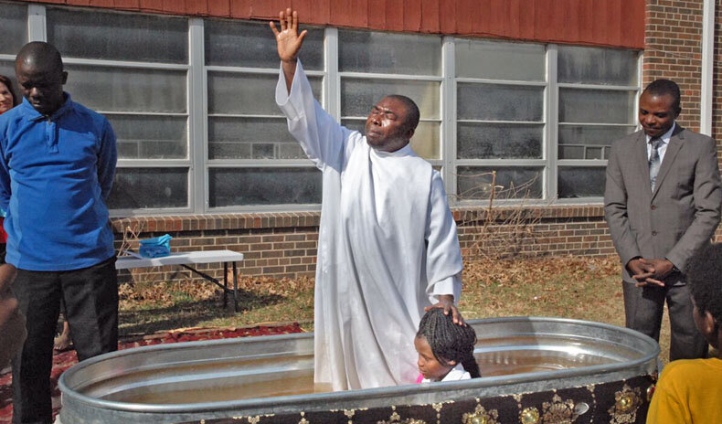  Pastor Fataki Mutumbala and Solomon Kasongo during a baptism.    Photo Credit: Steve Mencher 