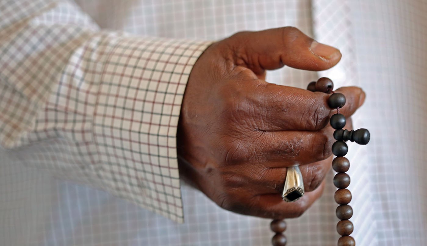 Wendell El-Amin James fingers Muslim prayer beads.