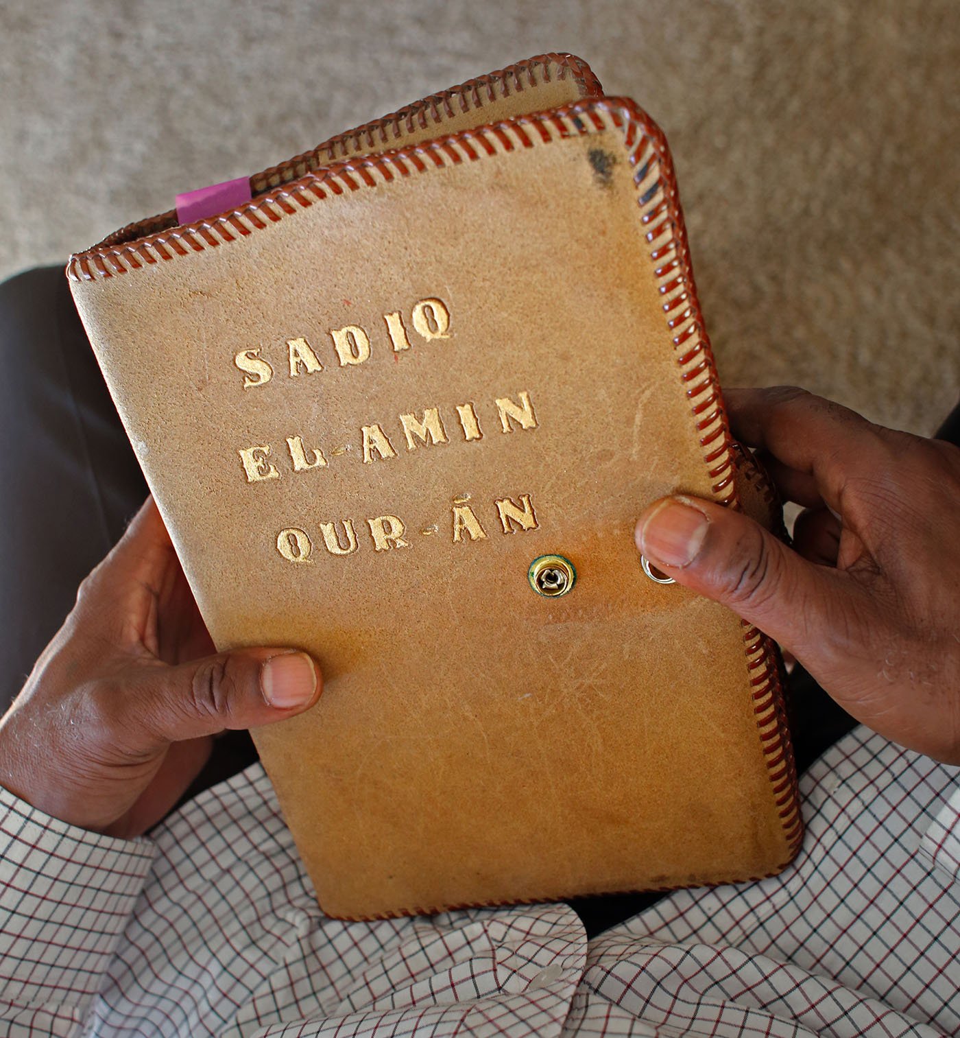 Wendell El-Amin James holds his favorite Qur'an. Its cover was made by another incarcerated man he knew when he was in prison.