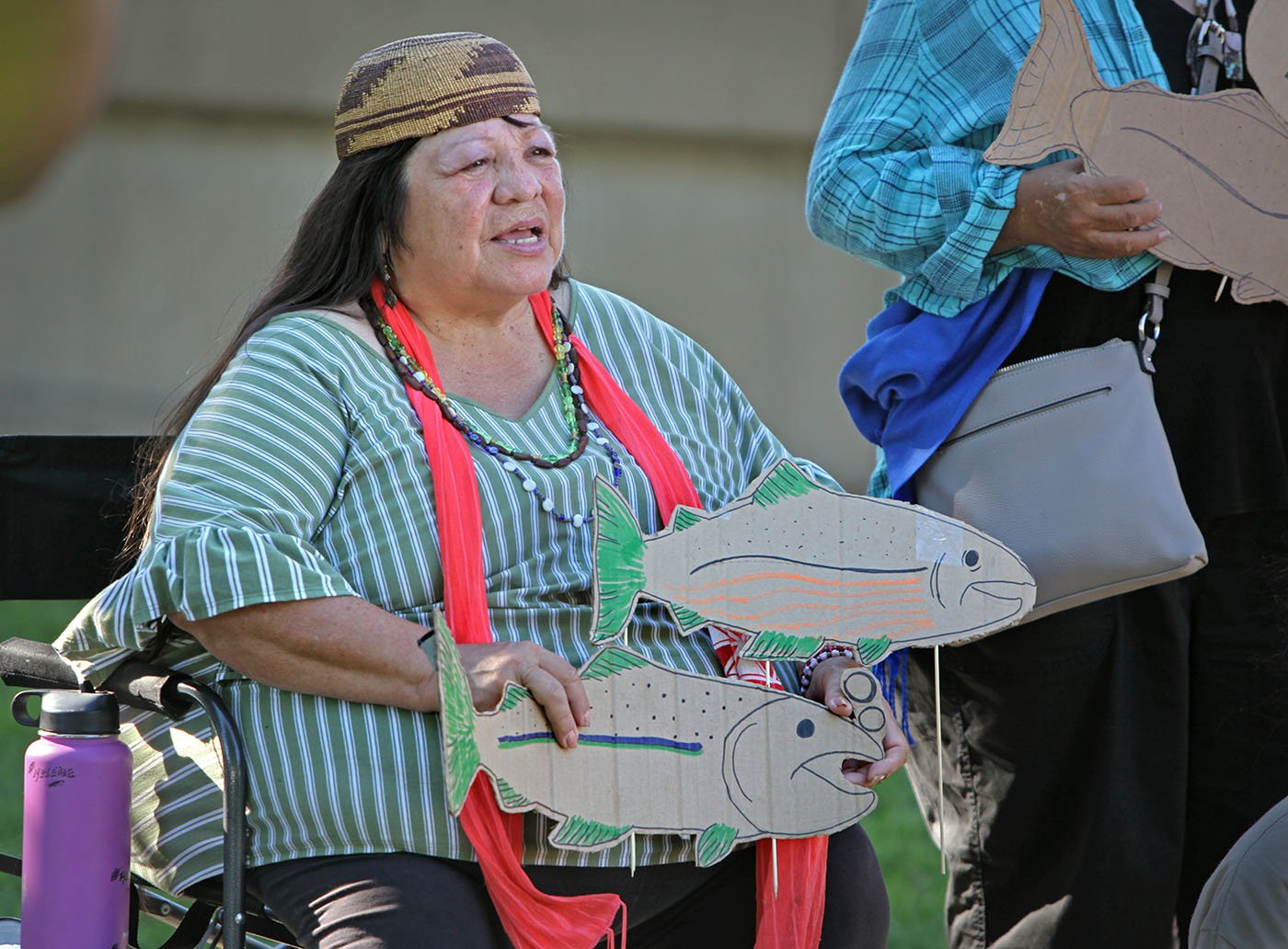  Shasta Lake, CA — Winnemem Wintu song leader Helene Sisk joins a protest outside the Shasta Dam Visitor Center.  September 25, 2019. Tom Levy/The Spiritual Edge 