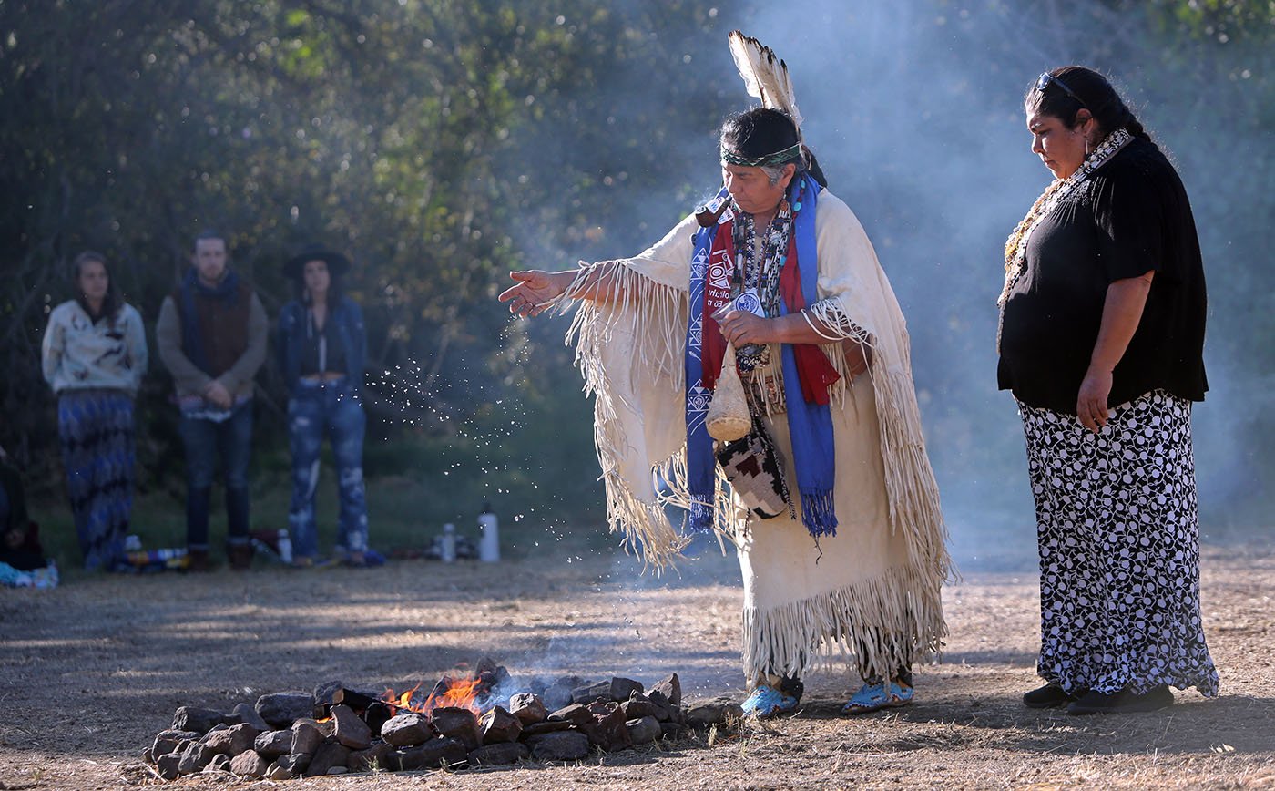  Vallejo, CA — Winnemem Wintu Chief Caleen Sisk drops tobacco on a sacred fire for the Run4Salmon opening ceremony. At her side is Lisjan Ohlone spokesperson Corrina Gould. September 9, 2017. Tom Levy/The Spiritual Edge 