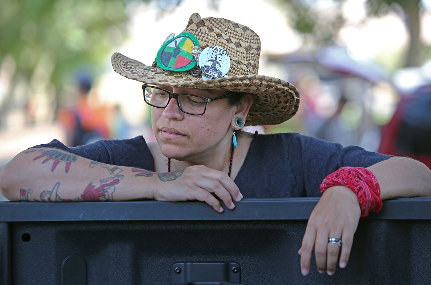  Concord, CA — A woman takes a break during the Run4Salmon. She wears a button that reads, 'Water is Sacred.’ September 11, 2017. Tom Levy/The Spiritual Edge 