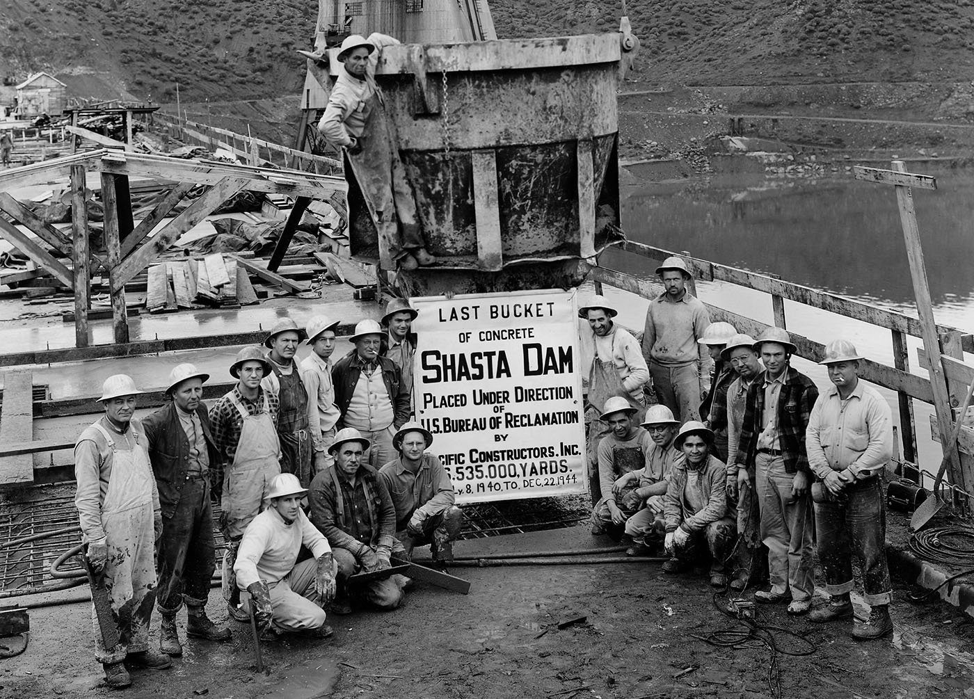  Shasta County — Crew of Pacific Constructors, Inc. grouped around the last bucket of concrete spilled for Shasta Dam on Dec. 22, 1944. U.S. Bureau of Reclamation, Central Valley Project History   