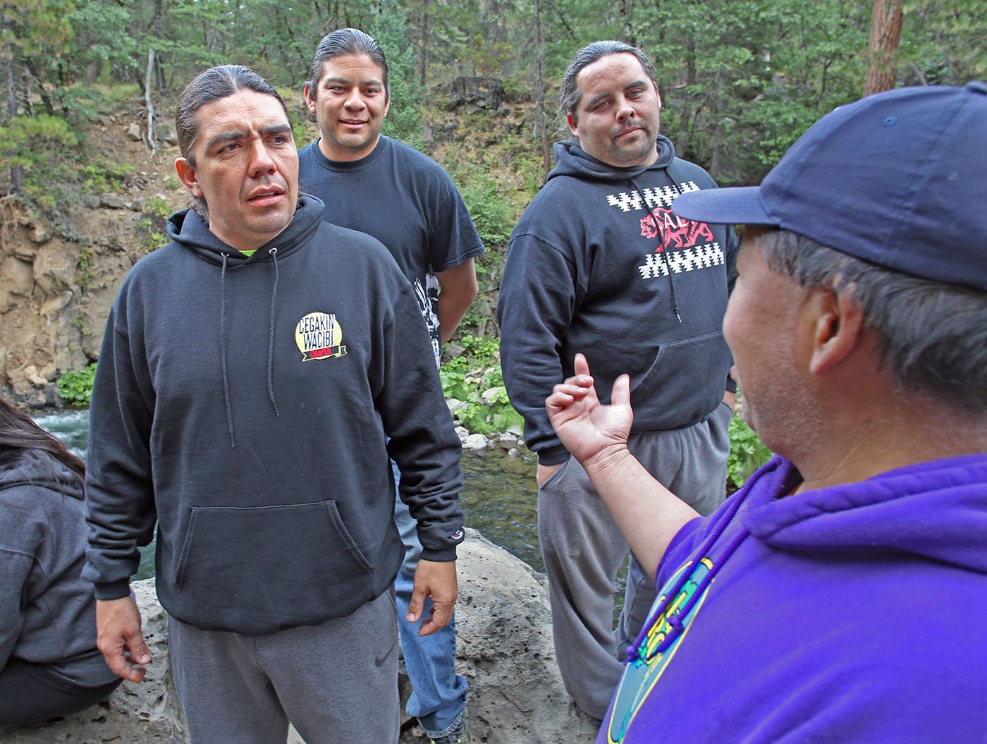  Lower McCloud River Falls, CA — Doug Scholfield speaks with other Winnemem Wintu men at the lower falls of the McCloud River. July 10, 2019. Tom Levy/The Spiritual Edge 