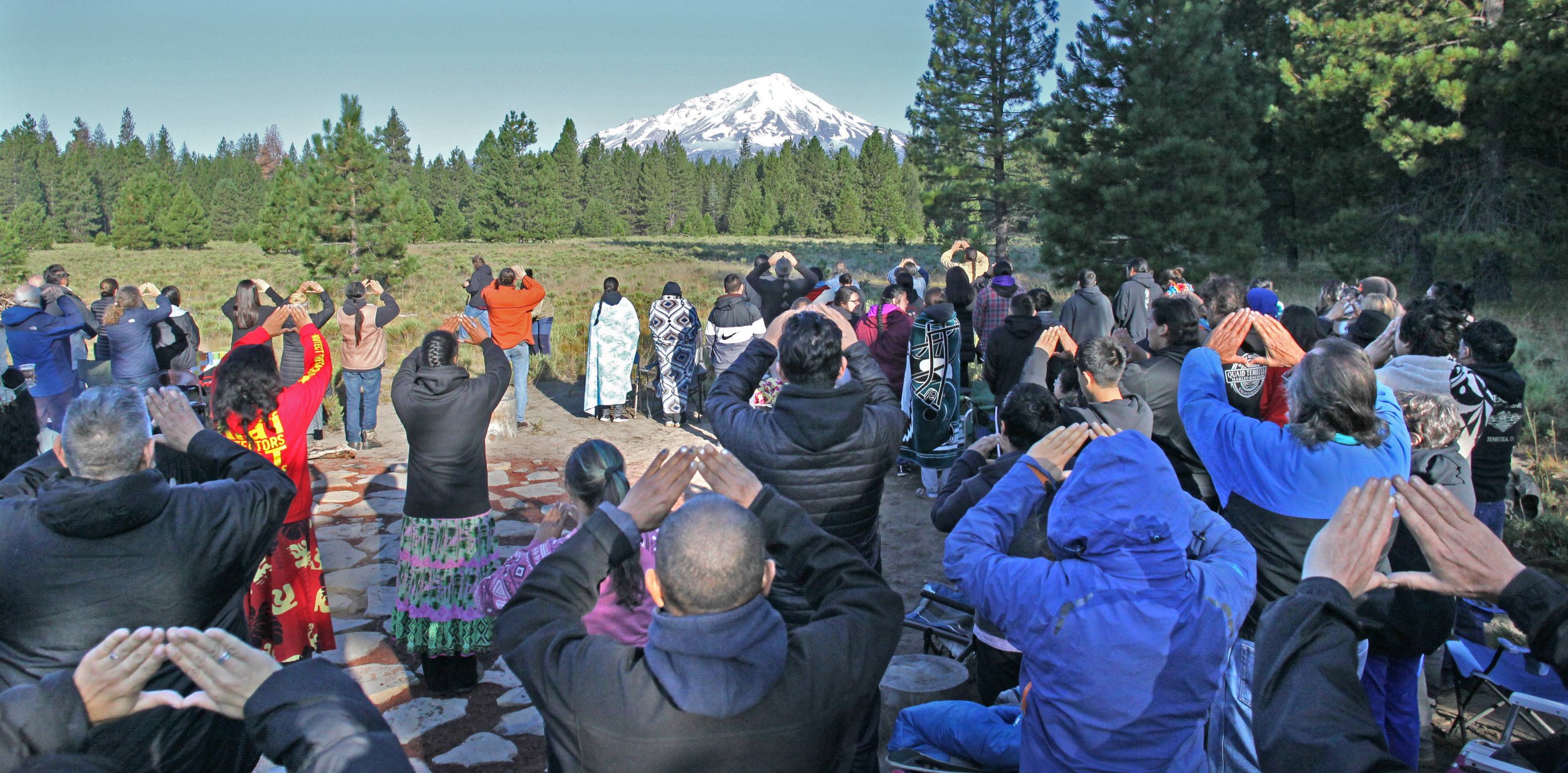  McCloud, CA — The Winnemem Wintu and friends gather for a sunrise ceremony near the base of Mt. Shasta. That morning, they saw an image of a bear with salmon on the mountain’s slopes. August 11, 2019. Tom Levy/The Spiritual Edge 