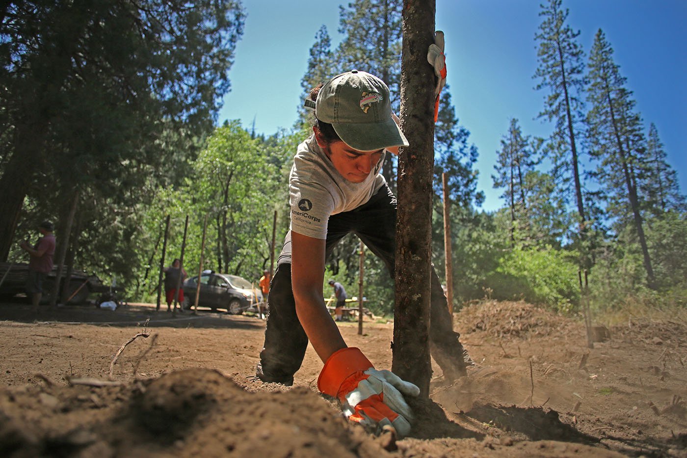  Shasta-Trinity National Forest — Samuel Funakoshi, a volunteer with the California Department of Fish and Wildlife, helps out with building of the ceremonial arbor. July 11, 2022. Tom Levy/The Spiritual Edge 