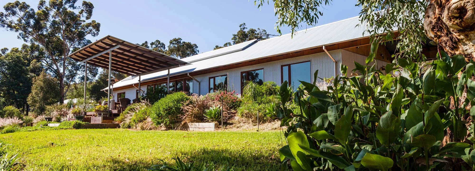 The Good Life passive solar home design project view from back yard.