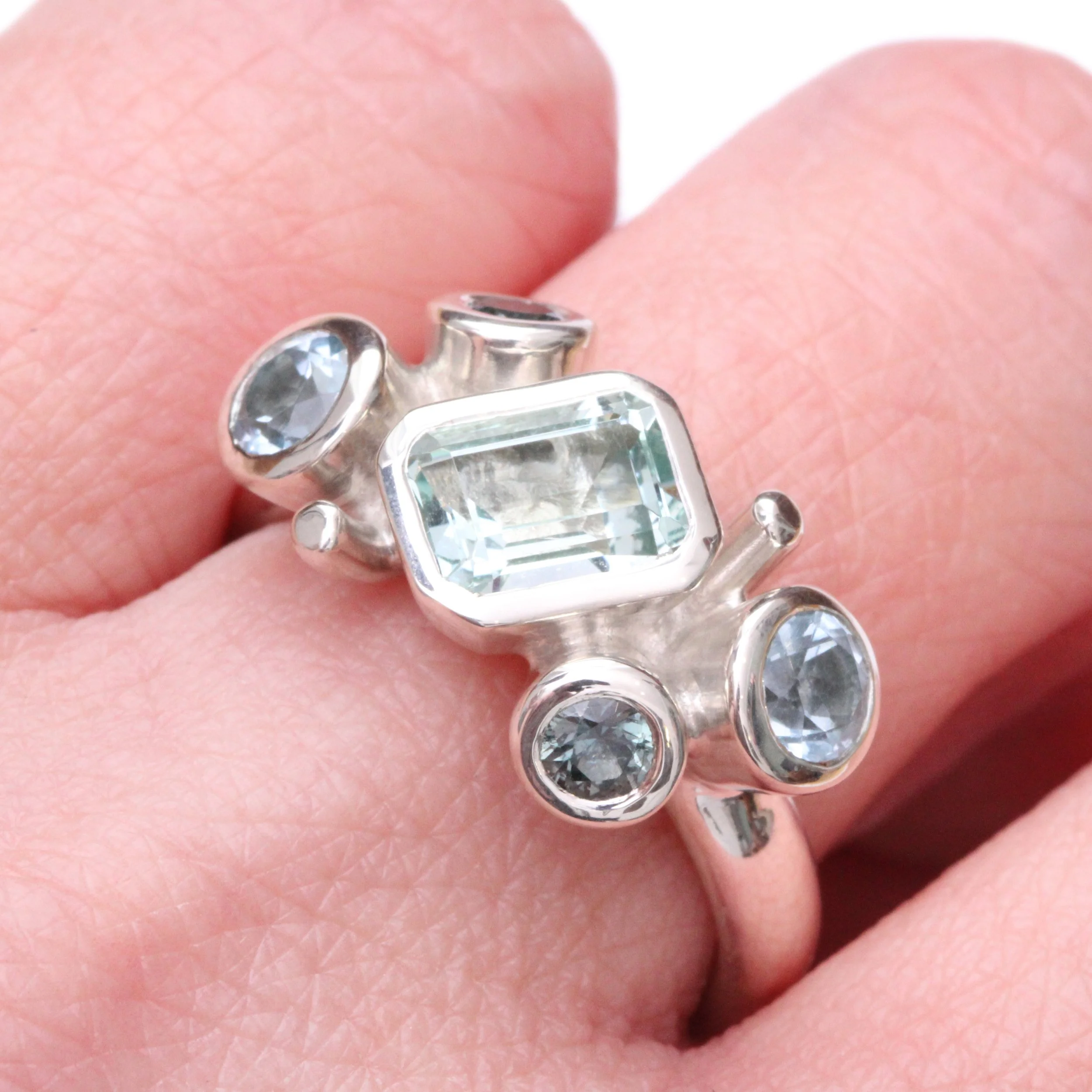 Silver Green Beryl Topaz and Teal Sapphires hand.jpg