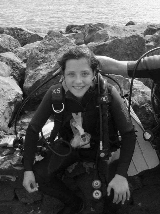 Childhood photo of Meriel learning to scuba dive, inspiring a lifelong love of adventure travel.