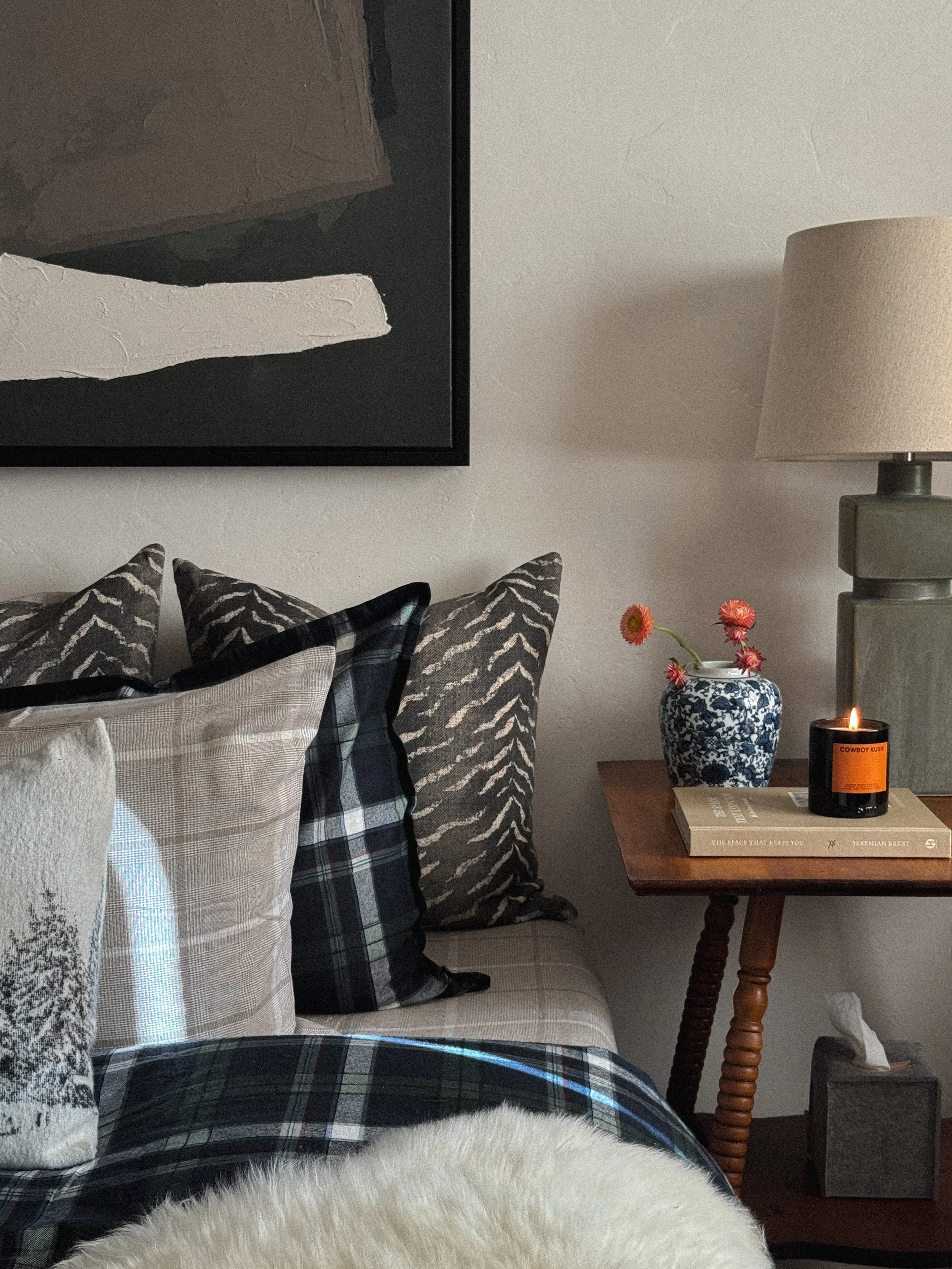 Mountain modern bedroom interior design in Steamboat Springs, Colorado, featuring texture, pattern mix deco pillows, cozy bedding, green creamic lamp and abstract art Studio Rhodes Design Interior design denver