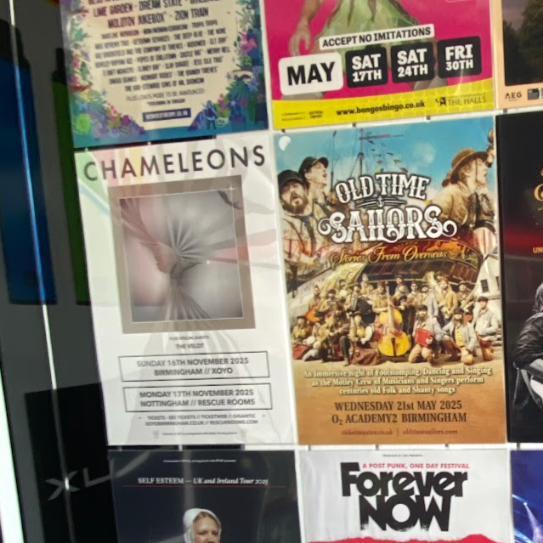 Various event posters on a notice board, including a flyer for Chameleons, an Old Time Sailors event, and other performances scheduled for November and May in Birmingham and Nottingham.