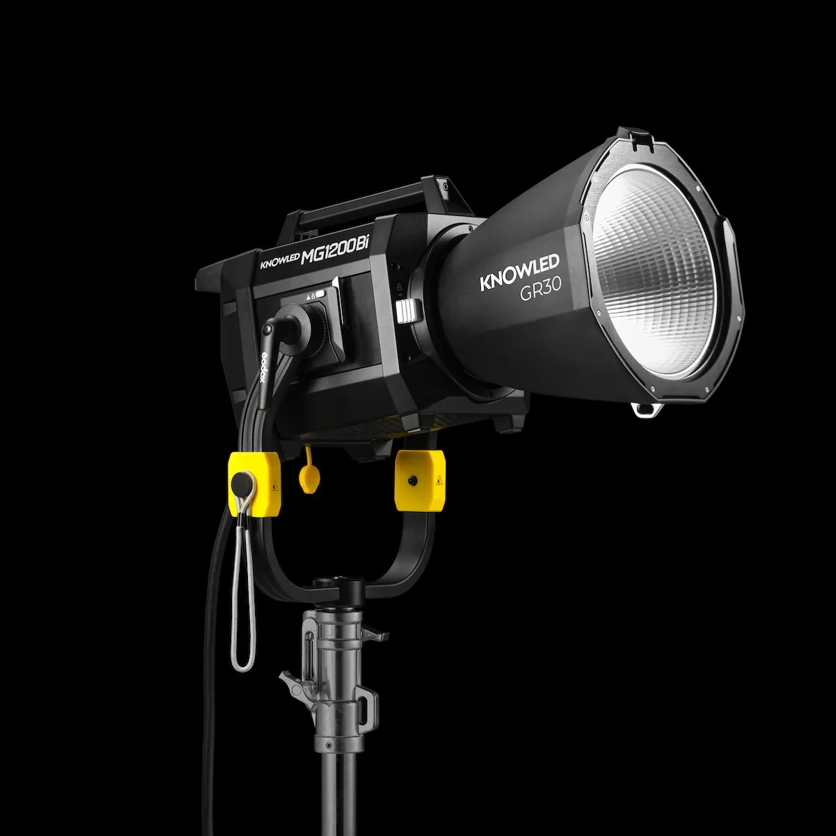 Photograph of a professional studio flash light labeled KNOWLED, mounted on a stand against a black background.