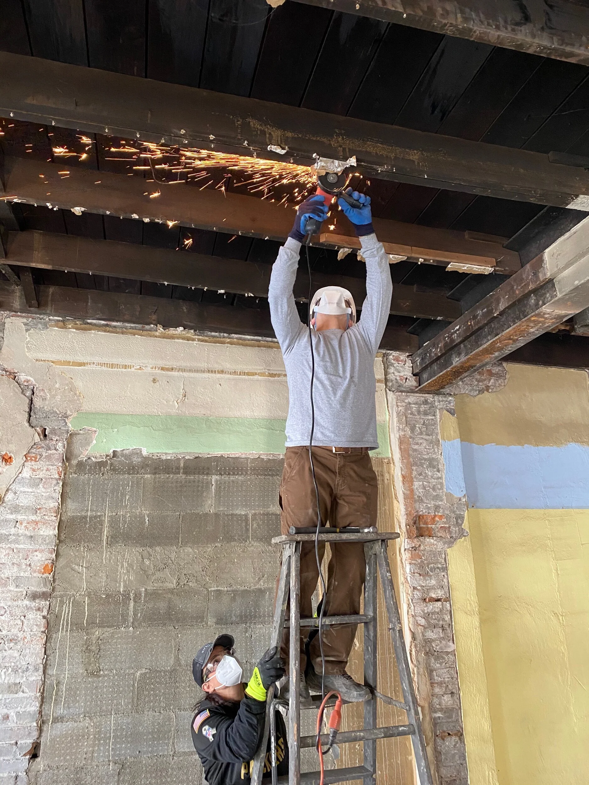 Grinding down nails and staples from the interior ceiling joists.