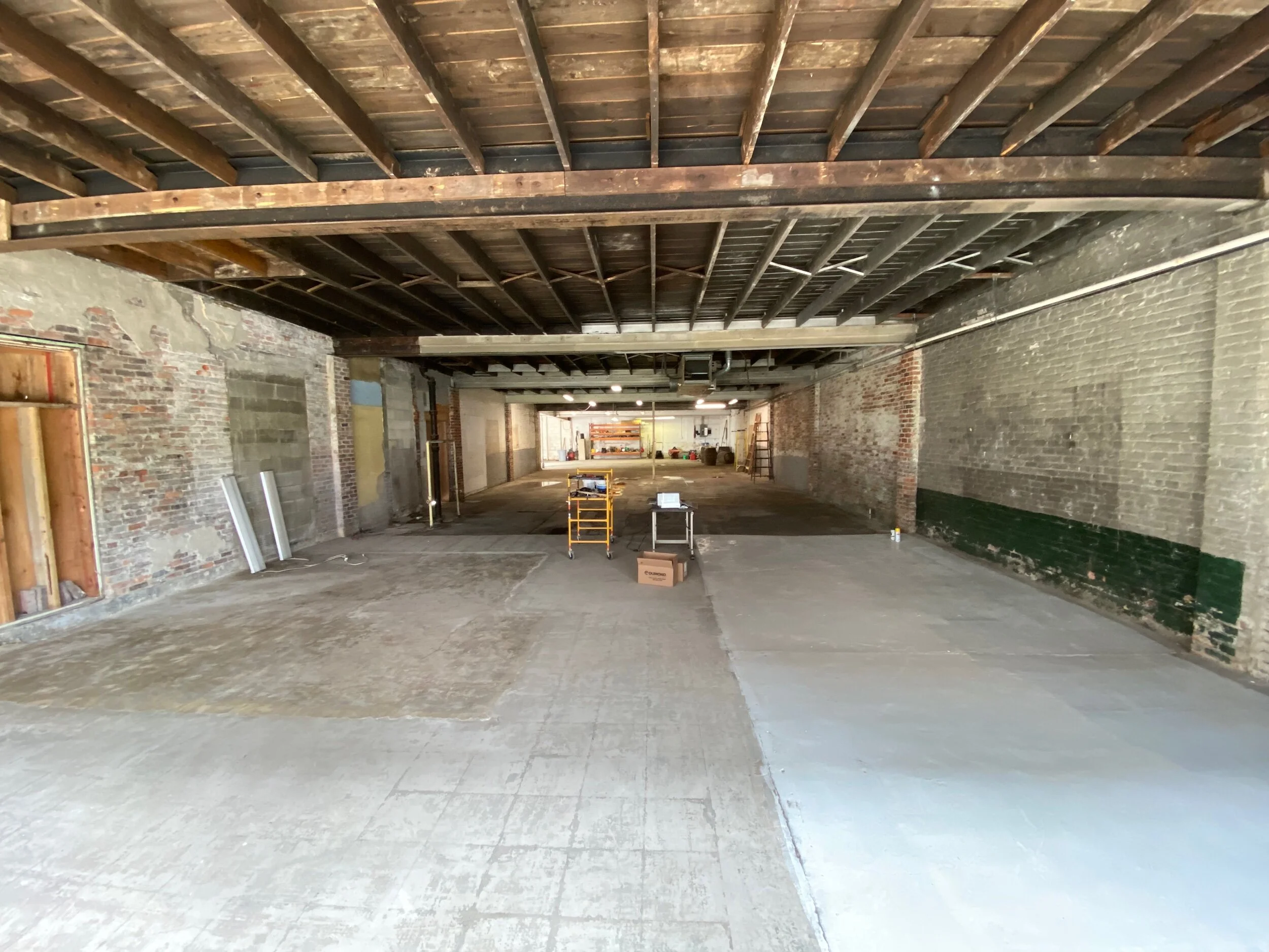 A view from the front looking to the back. All of the interior walls and ceilings have been cleared.