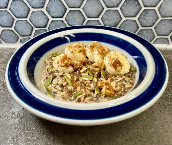Bowl_of_Cinnamon_Overnight_Oats_with_banana_and_walnuts (1).webp