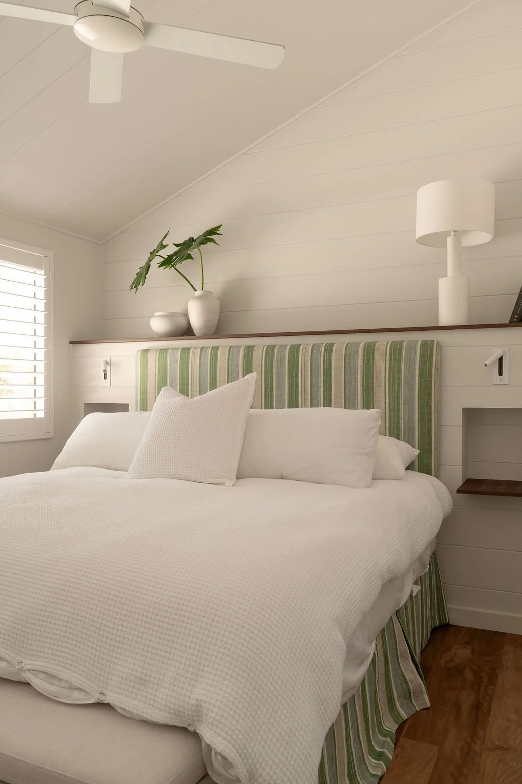 Noosa, Queensland- guest bedroom with paneling and upholstered headboard