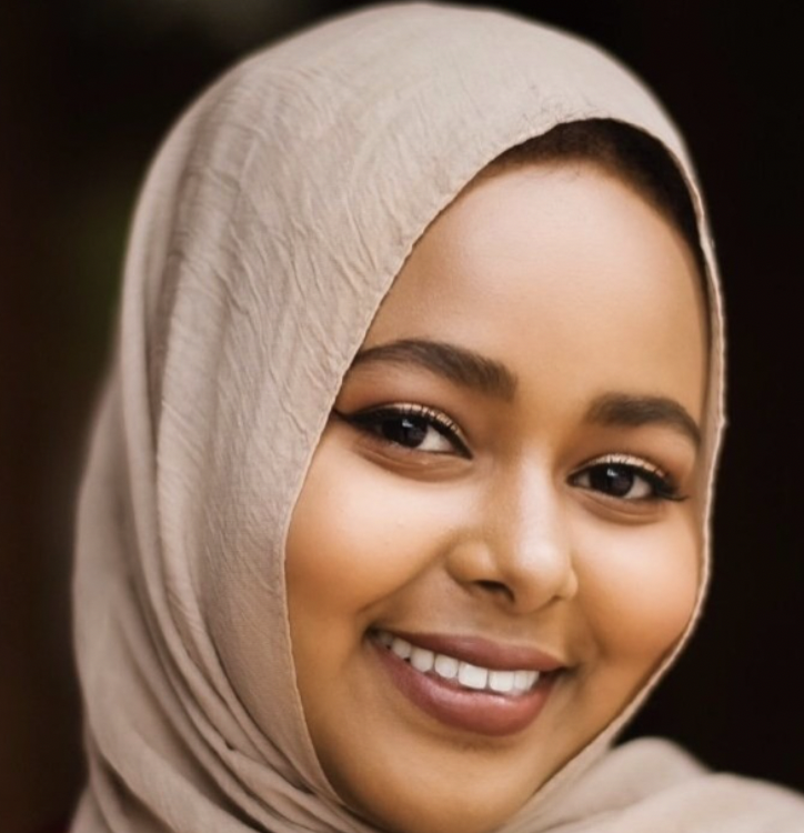 Newal Osman, OTD, OTR/L, smiling in a beige headscarf
