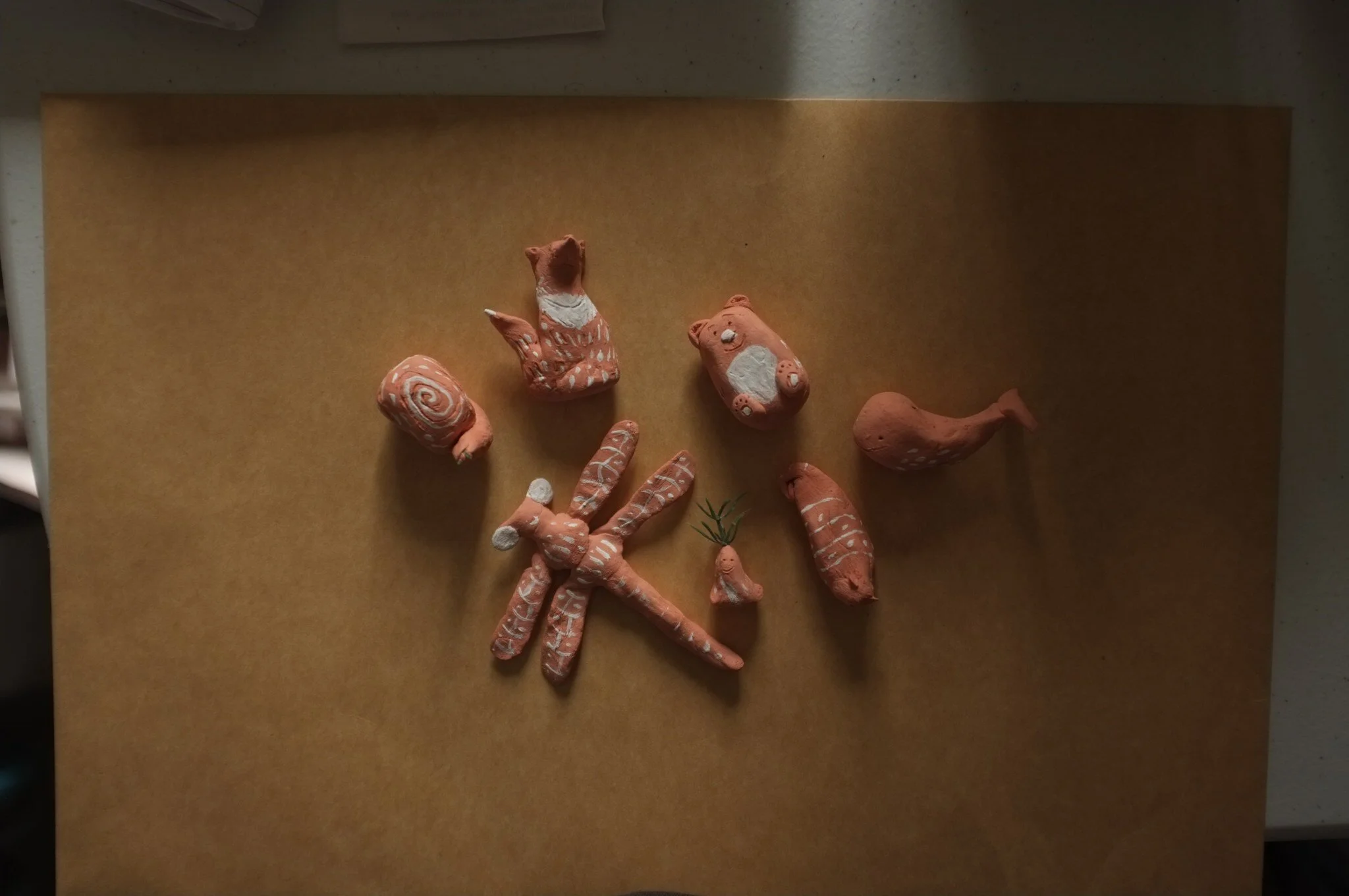 Dirty hands, red earth, and clay creatures