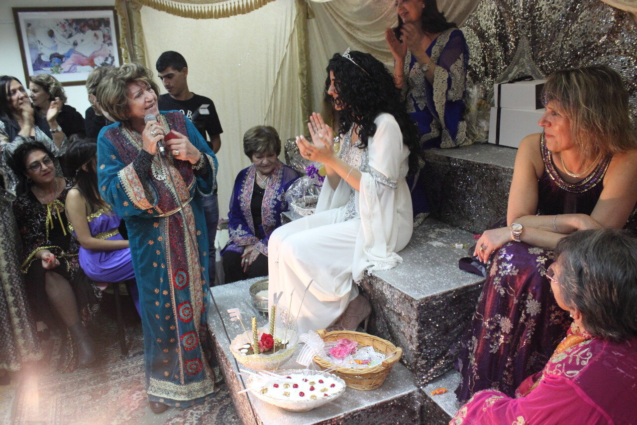  A bride's grandmother sings to her at a Persian henna celebration. Rishon Le Zion, 2015. 