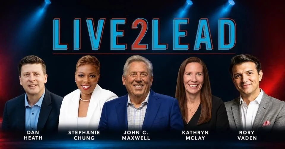 Group photo of five news anchors standing in front of a dark background with a red and blue gradient. The text 'LIVE2LEAD' is displayed above them. From left to right: Dan Heath, Stephanie Chung, John C. Maxwell, Kathryn McLay, and Rory Vaden.