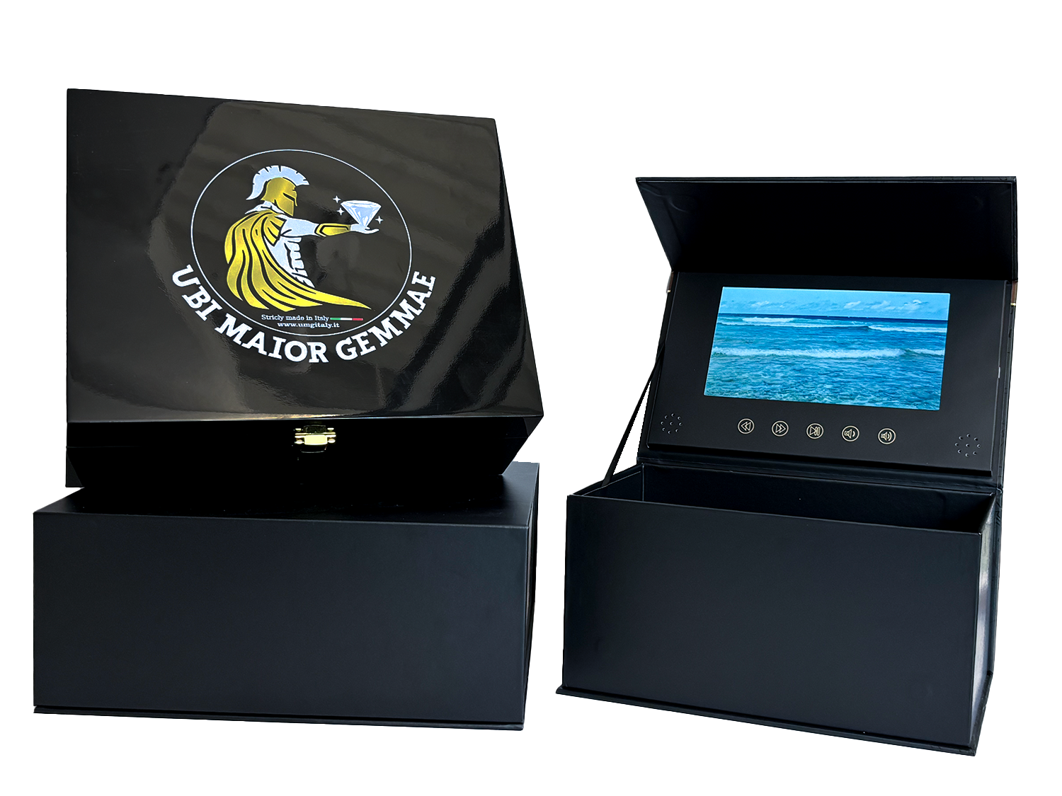 A black box with a logo of a warrior holding a diamond and the text 'UBI MAIOR GEMARIA' and a display device showing an ocean scene. influencer boxes A&H packaging video boxes 