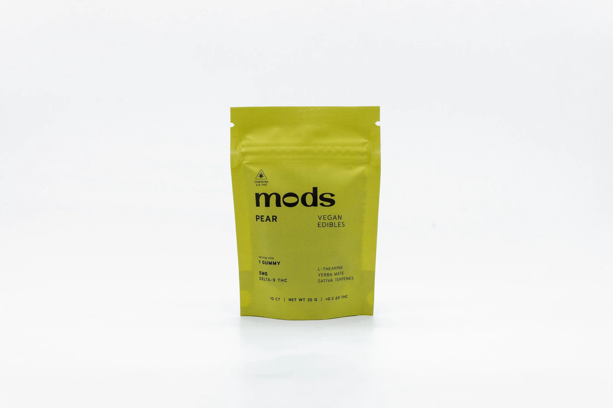 Bright yellow resealable bag labeled 'Mods Pear Vegan Edibles' with information about cannabis content and ingredients, standing upright against a plain white background.