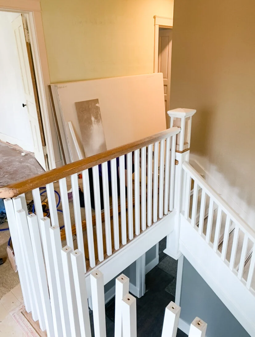 In this picture, we're halfway through adding the taller balusters and reconnecting the original handrail. Our drill got a workout - we drilled holes in the top and bottom of 42 balusters as well as corresponding holes in the baseboard and handrail