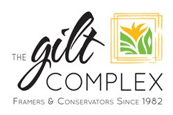 Logo for 'The Gilt Complex' featuring stylized text and a graphic of a yellow flower inside a decorative frame, with the tagline 'Framers & Conservators Since 1982.'