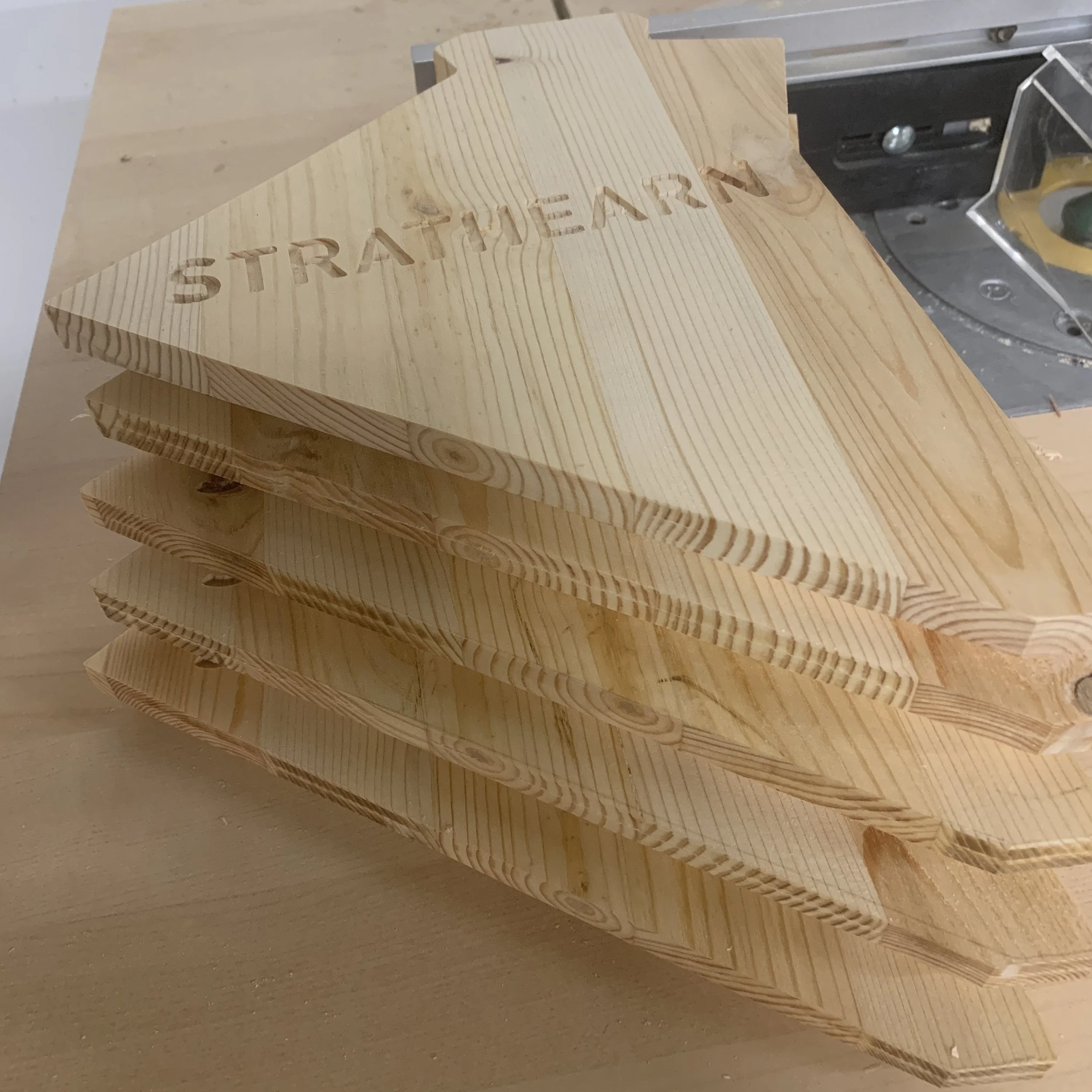 Stacked wooden plaques with the word 'STRATEGY' engraved on the top plaque.