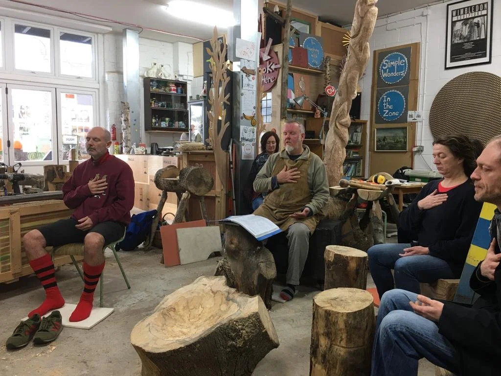Group of people meditating at the studio