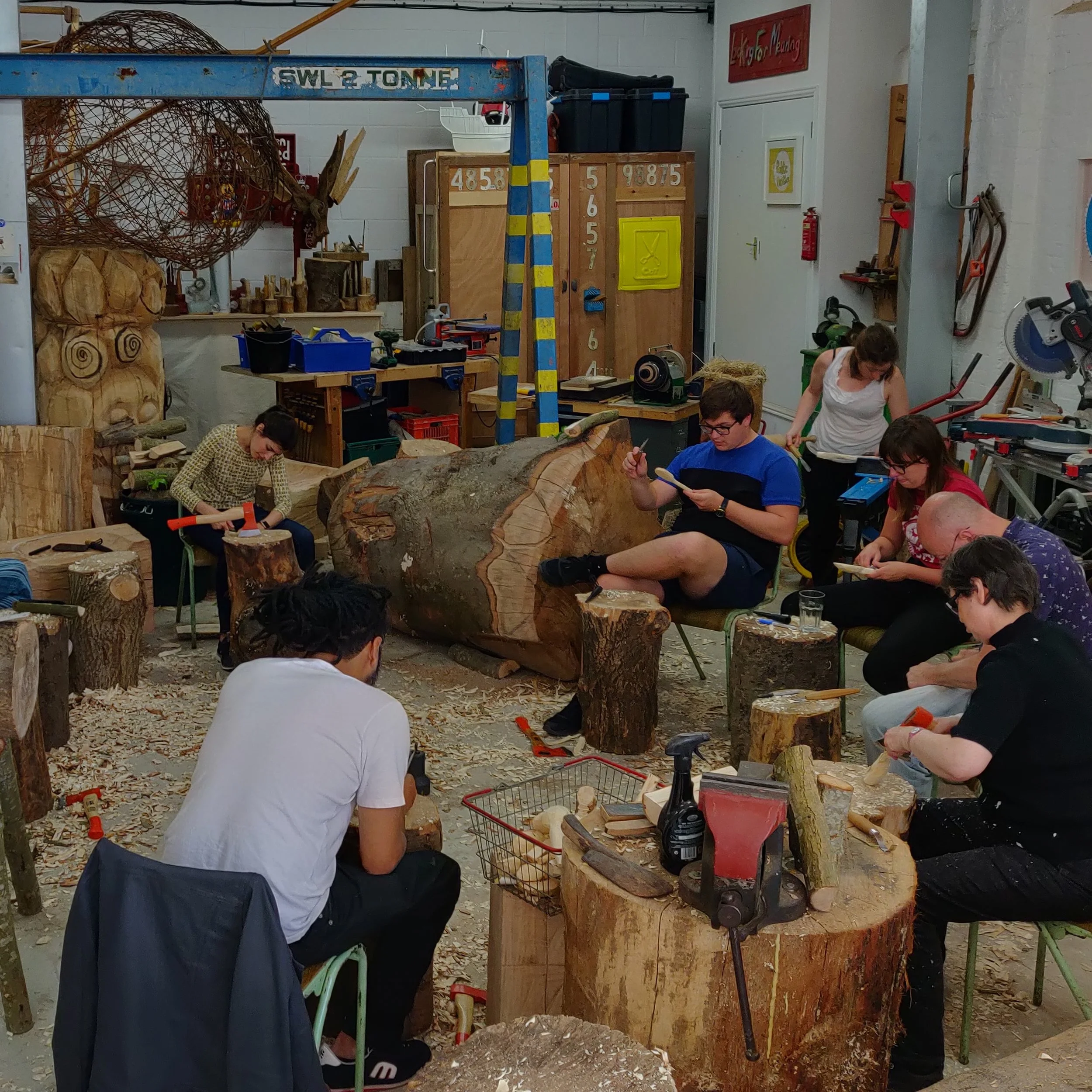 Group of people carving in the studio