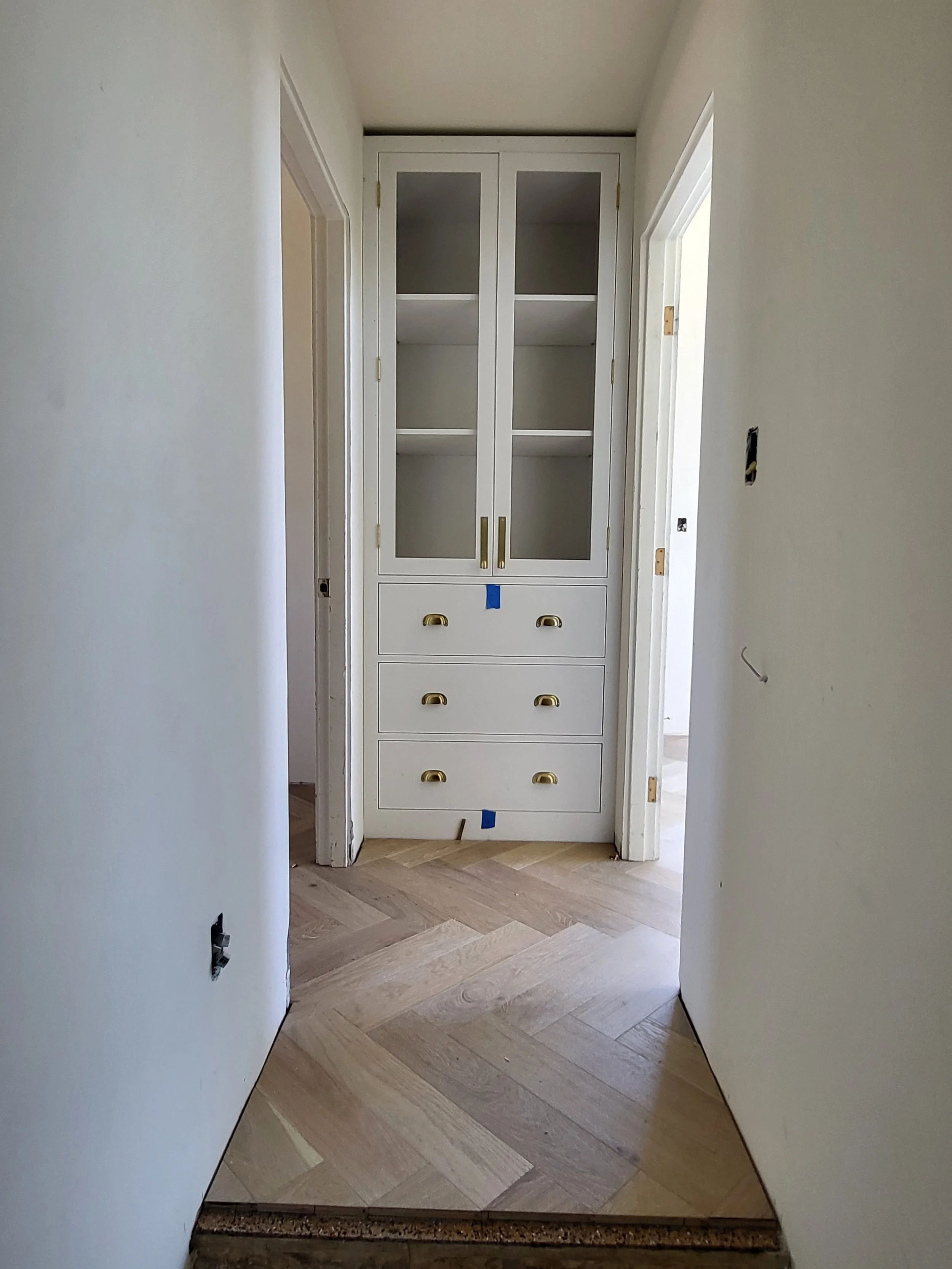 Linen cabinet waiting for flutted glass door panels