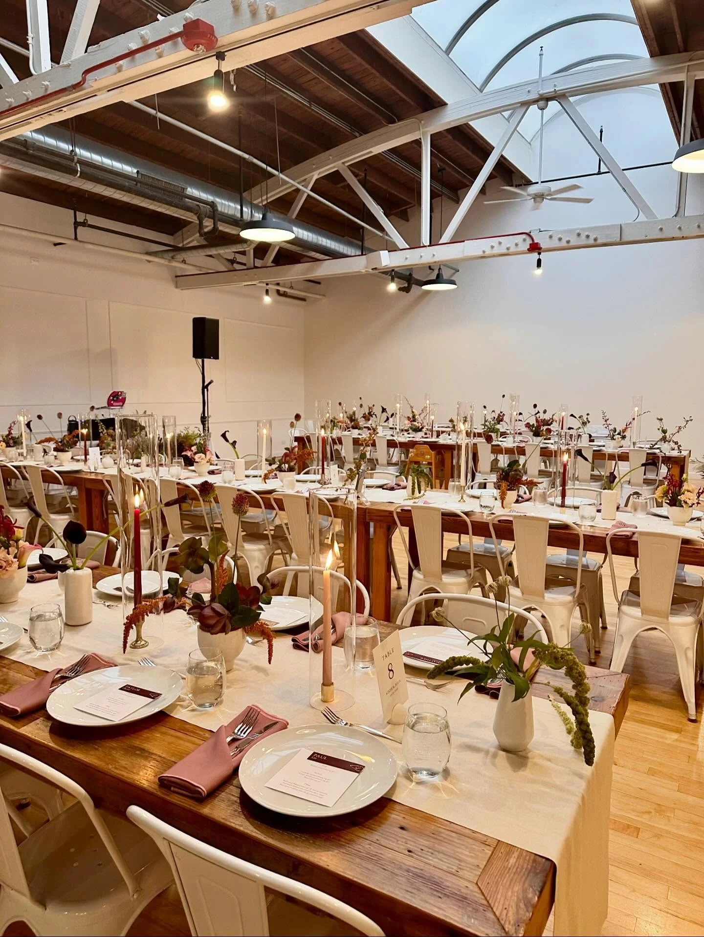 Addie + Julia&rsquo;s wedding reception. Fresh floral and taper candles lined the tables. Guests enjoyed a family style dinner with roasted chicken breast, crispy smashed potatoes, warm lentil and chickpea braise, beef short rib, and broccolini. It w