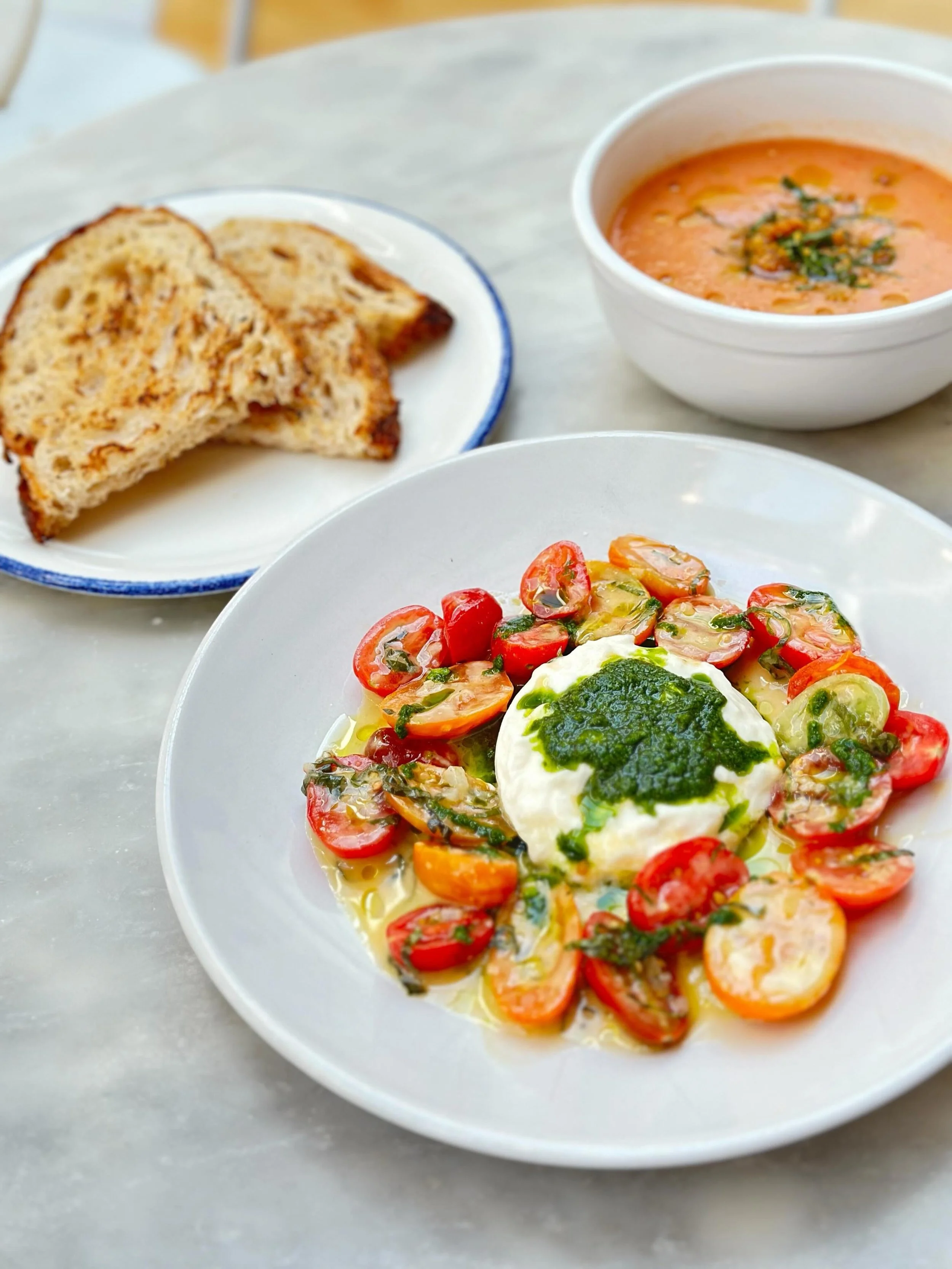 Our most popular summer cafe menu specials are back! Tomatoes &amp; Burrata featuring marinated heirloom tomatoes, burrata cheese, olive oil, and basil pesto (nut free), served with griddled country bread.

And Gazpacho, our light and delicious chill