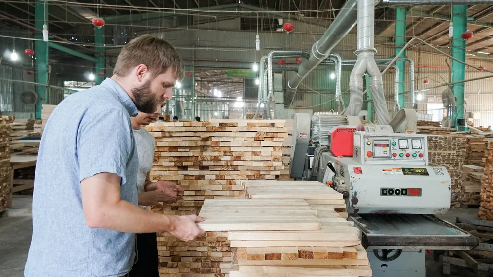 Jim Kennemer inspecting wood at a factory